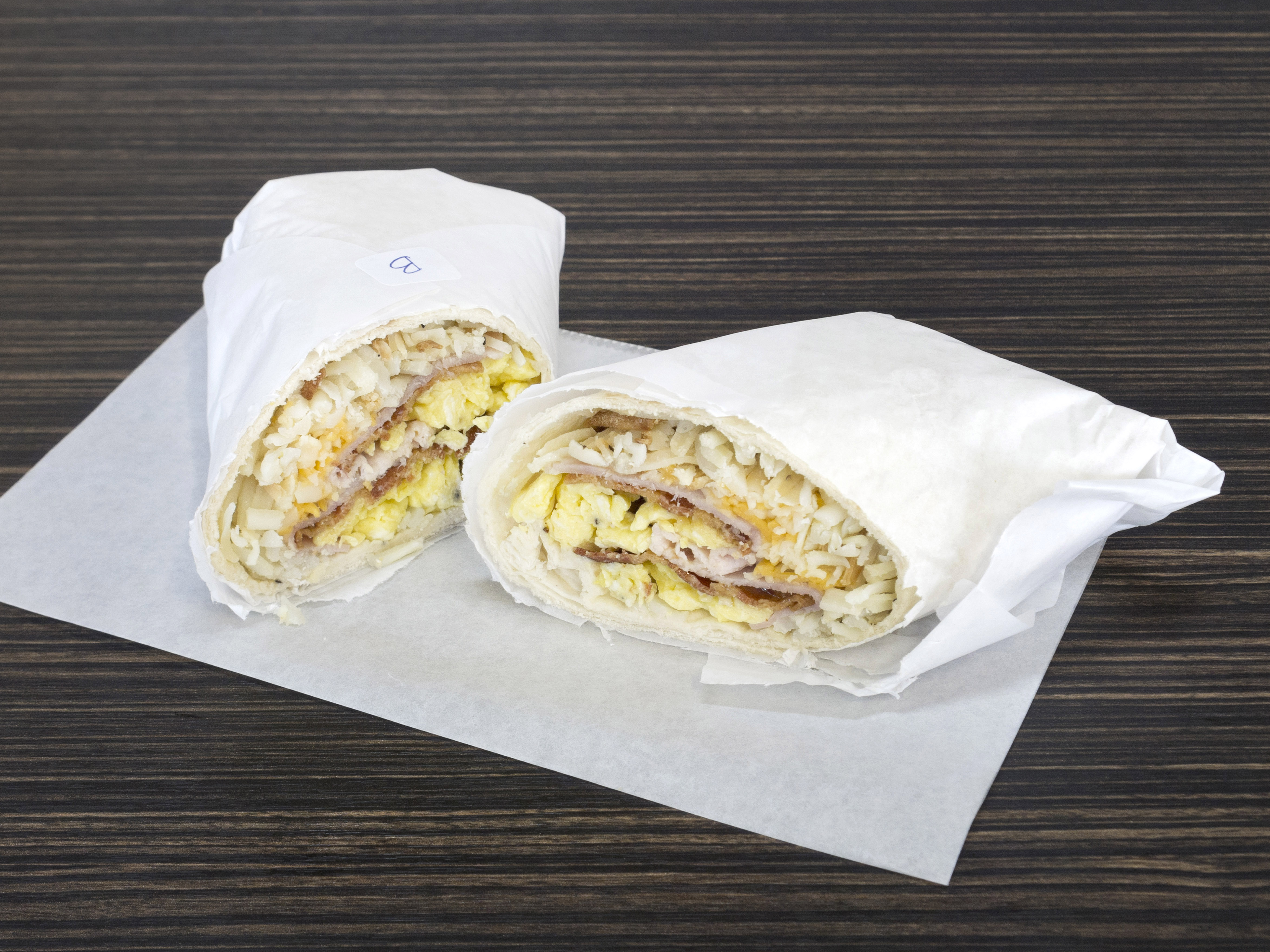 Order Bacon, Egg, Cheese and Hash Browns Burrito Breakfast food online from Red Oak Donuts store, Red Oak on bringmethat.com