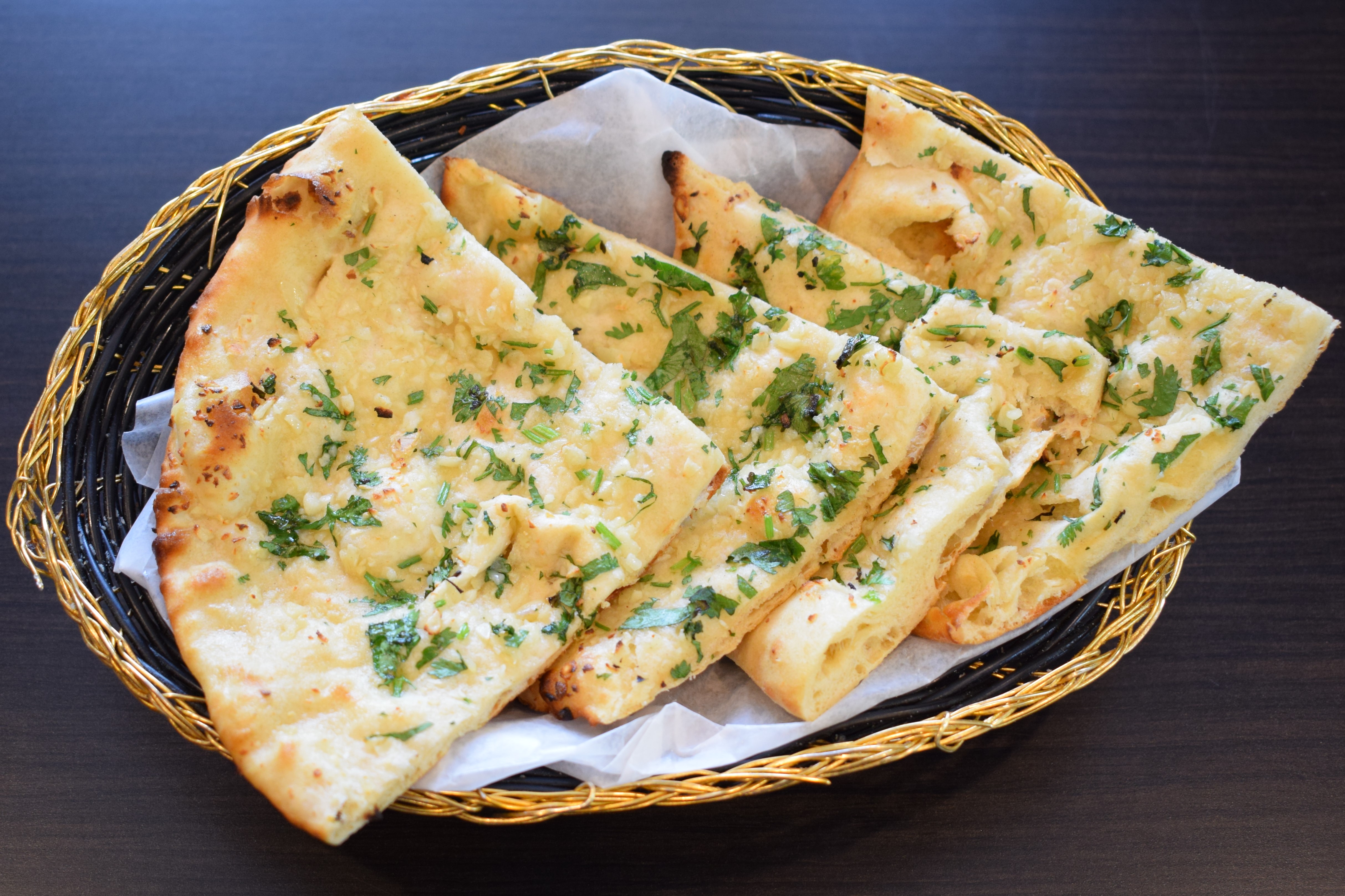 Order Garlic Naan food online from Crown Of India Restaurant store, Plainsboro on bringmethat.com