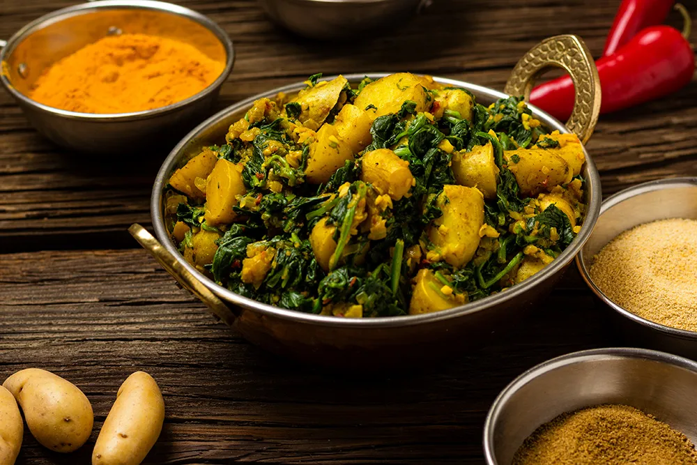 Order Saag Alu food online from King of Tandoor Fine Indian Restaurant store, Philadelphia on bringmethat.com