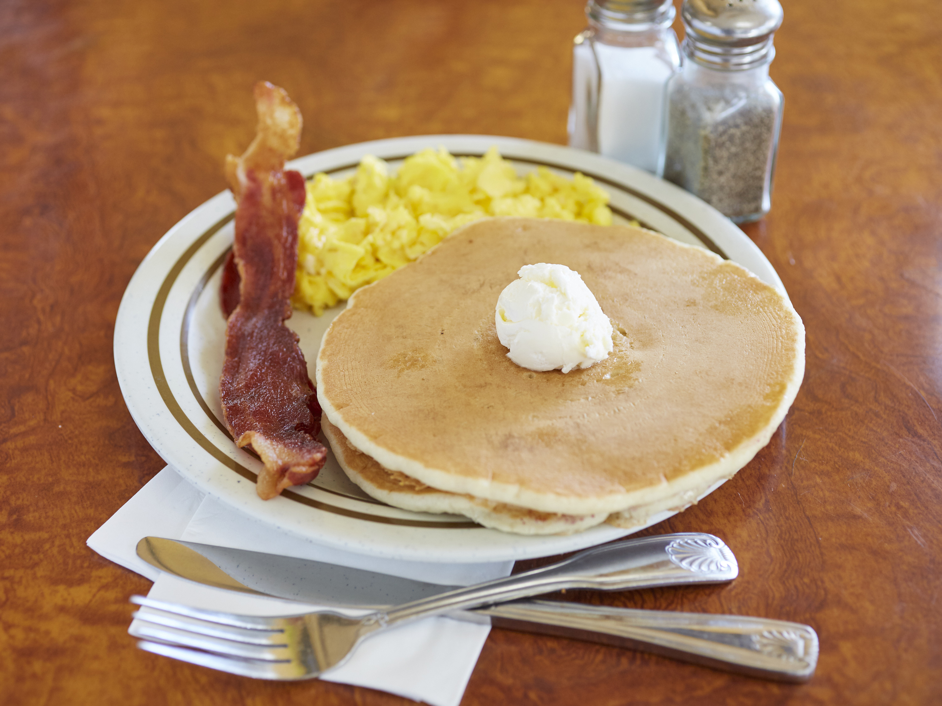 Order 2 Eggs, 2 Pancakes and 2 Bacon food online from Breakfast Cafe store, Oak Park on bringmethat.com