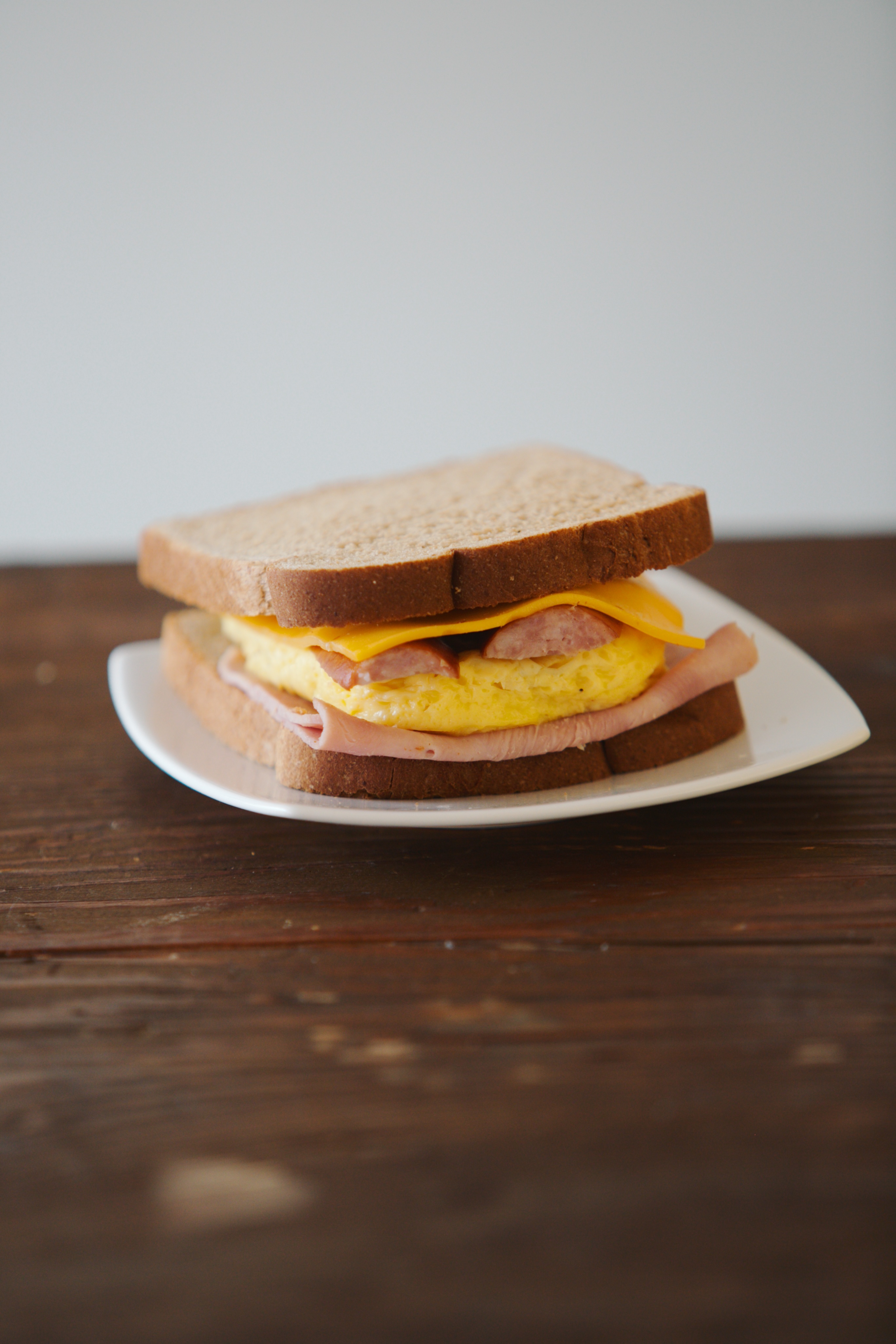 Order Egg, Ham, Sausage & Cheese Toasted Sandwich food online from White Cup Donuts store, Gardena on bringmethat.com