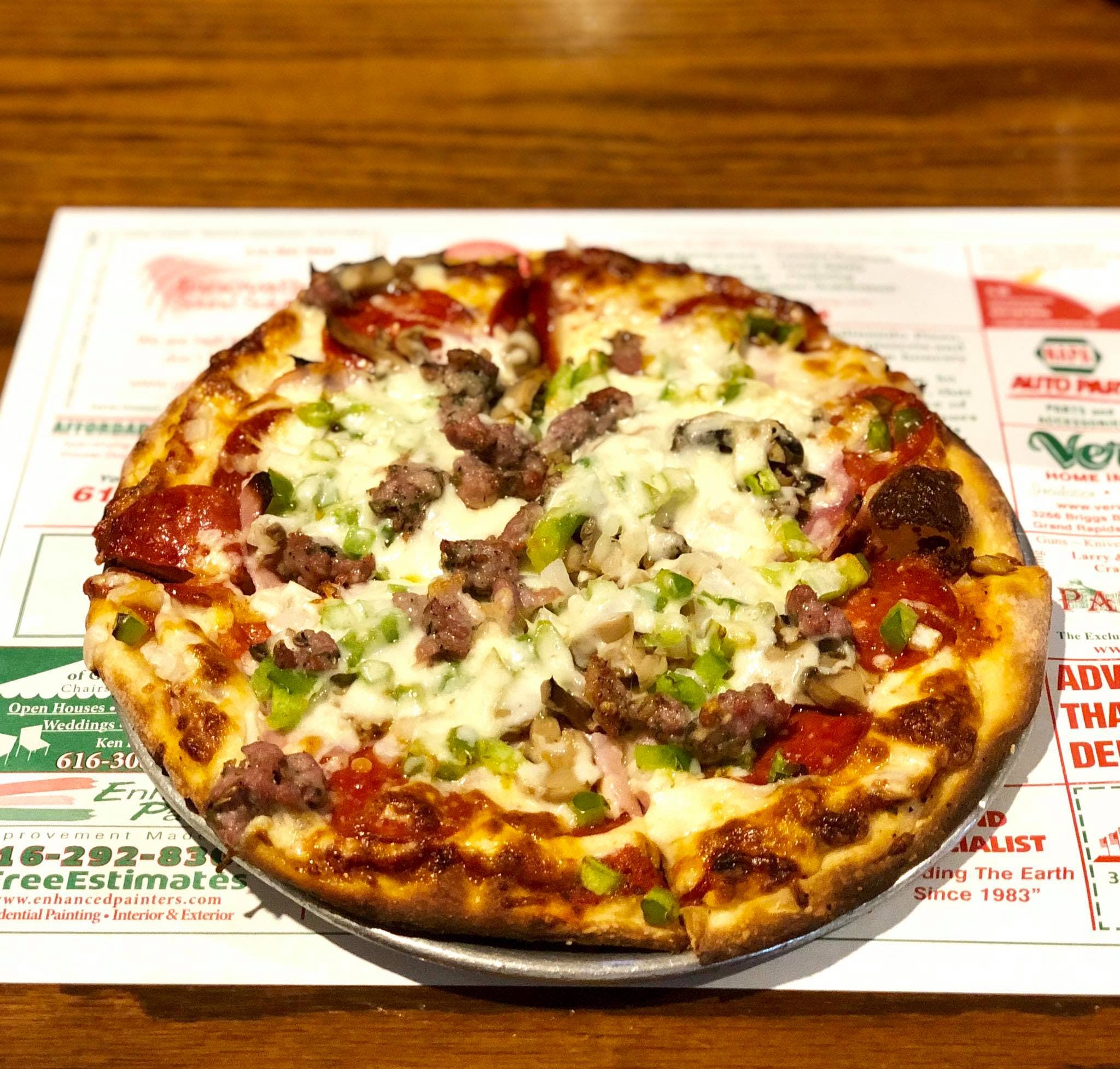 Order Deluxe Pizza - 10" food online from Freds Pizza & Italian Restaurant store, Grand Rapids on bringmethat.com