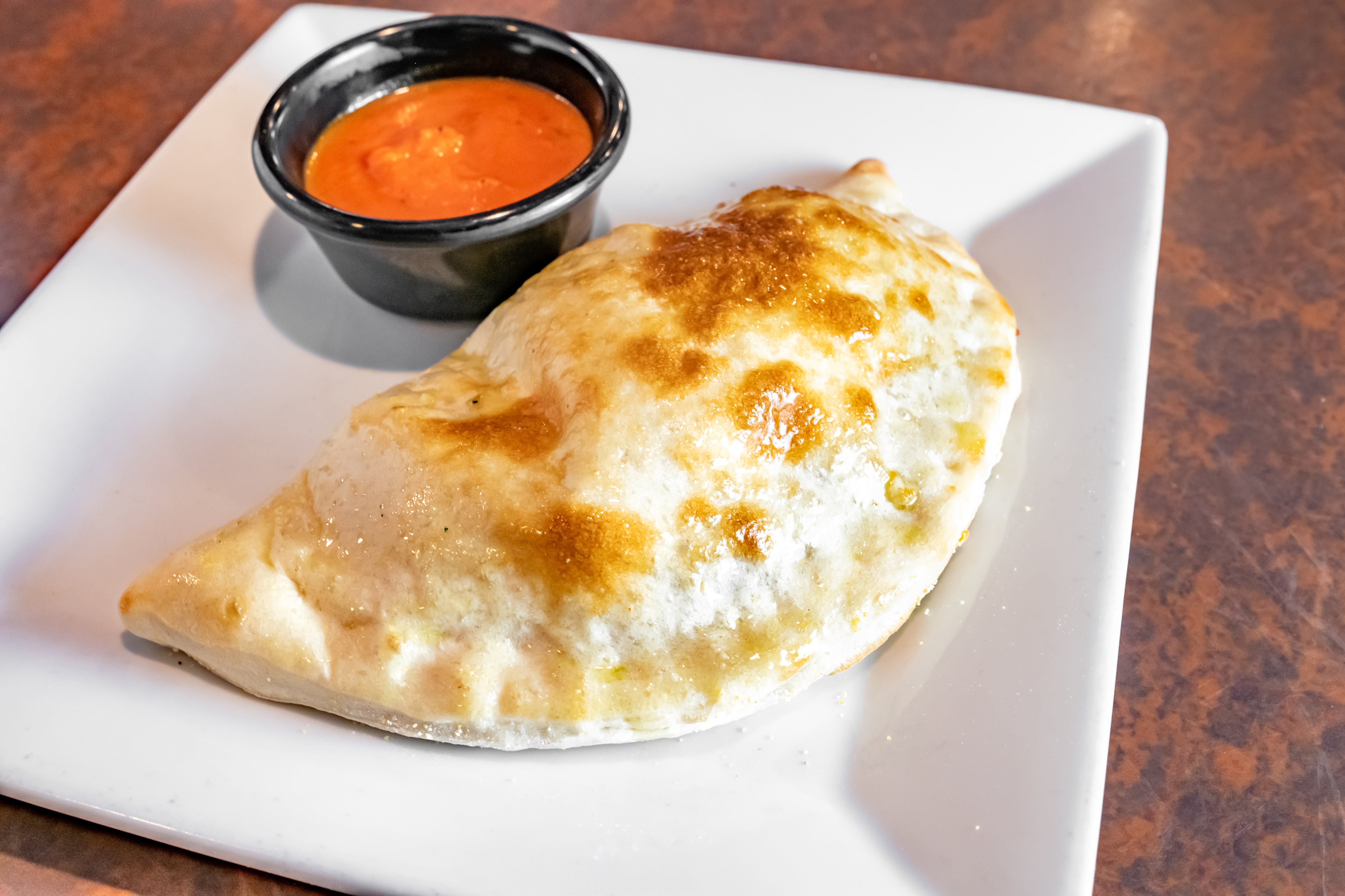 Order Calzone - Calzone food online from Paisano's store, Benbrook on bringmethat.com