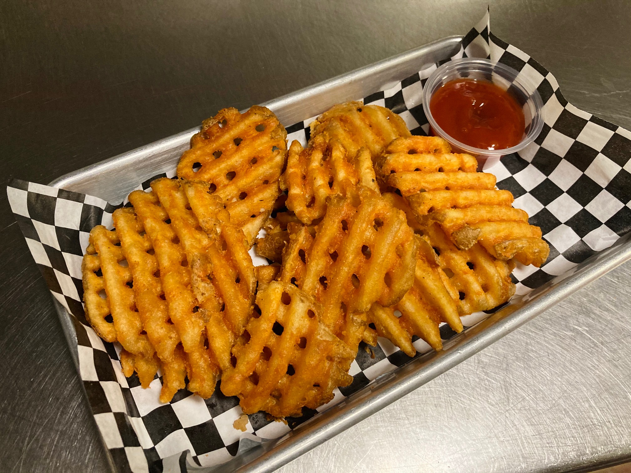 Order Seasoned Waffle Fries  food online from Saints Pub + Patio store, Independence on bringmethat.com