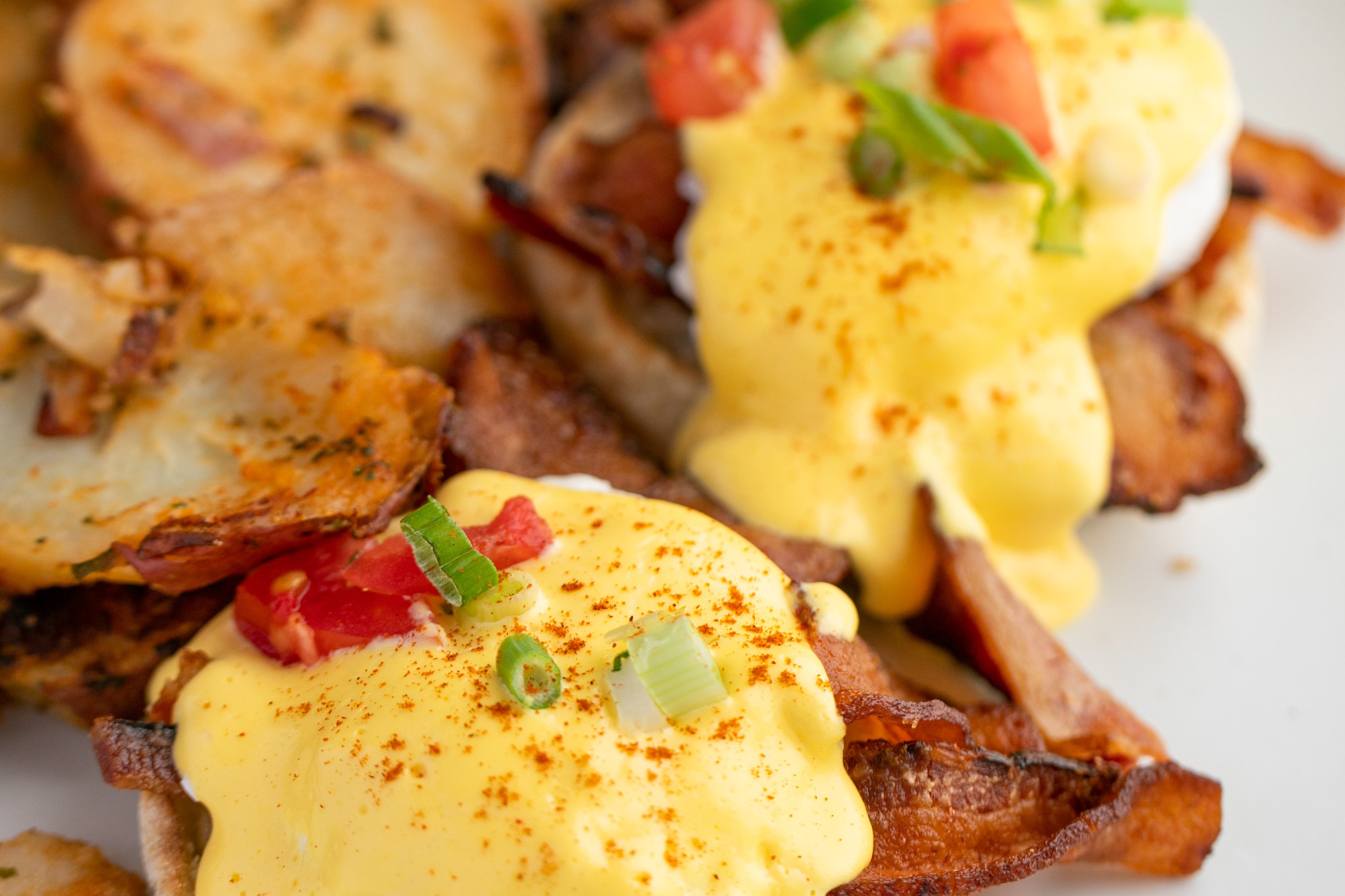 Order Eggs Benedict* food online from Swami Cafe store, San Diego on bringmethat.com