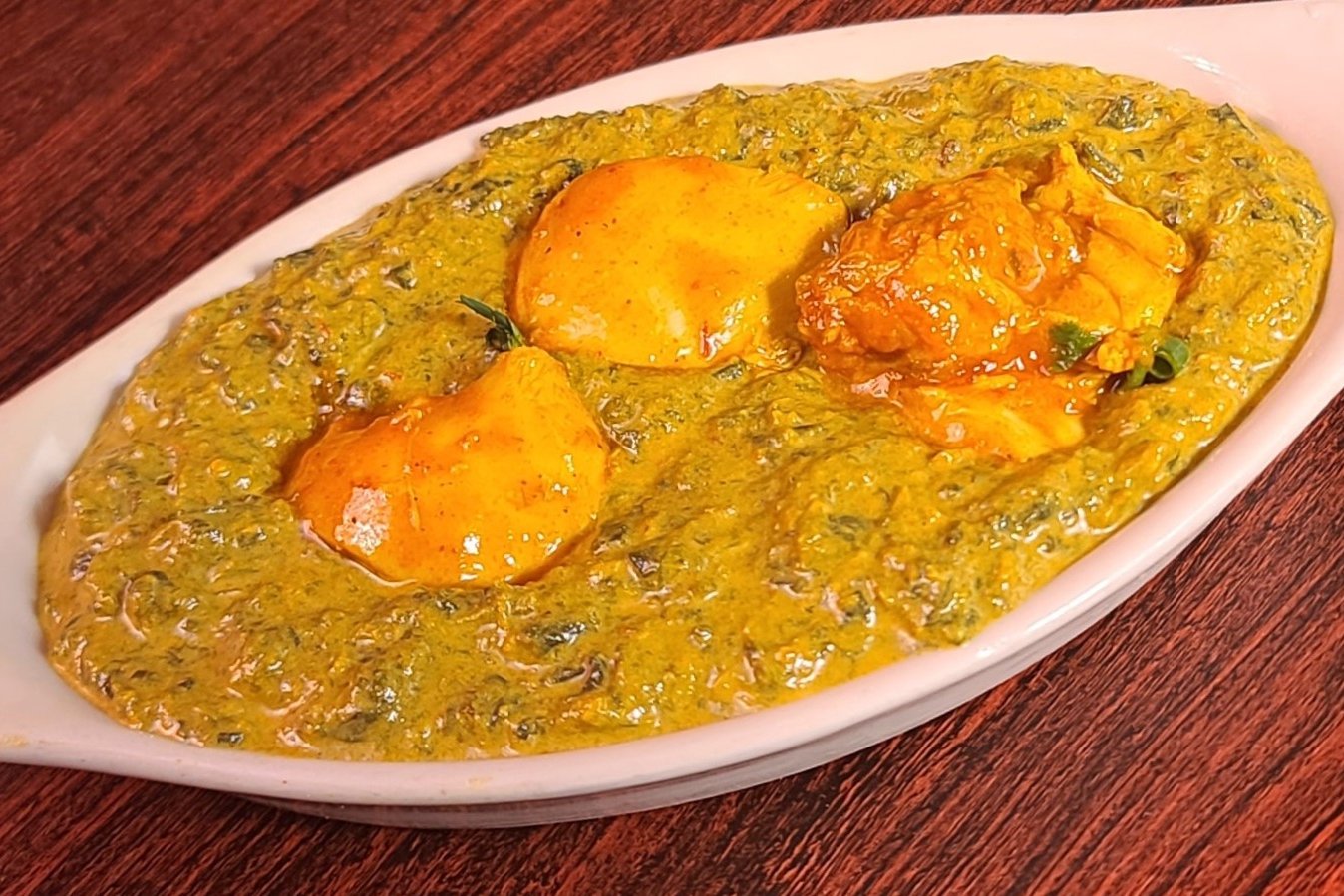 Order Chicken Saag food online from Om Indian Cuisine store, San Francisco on bringmethat.com