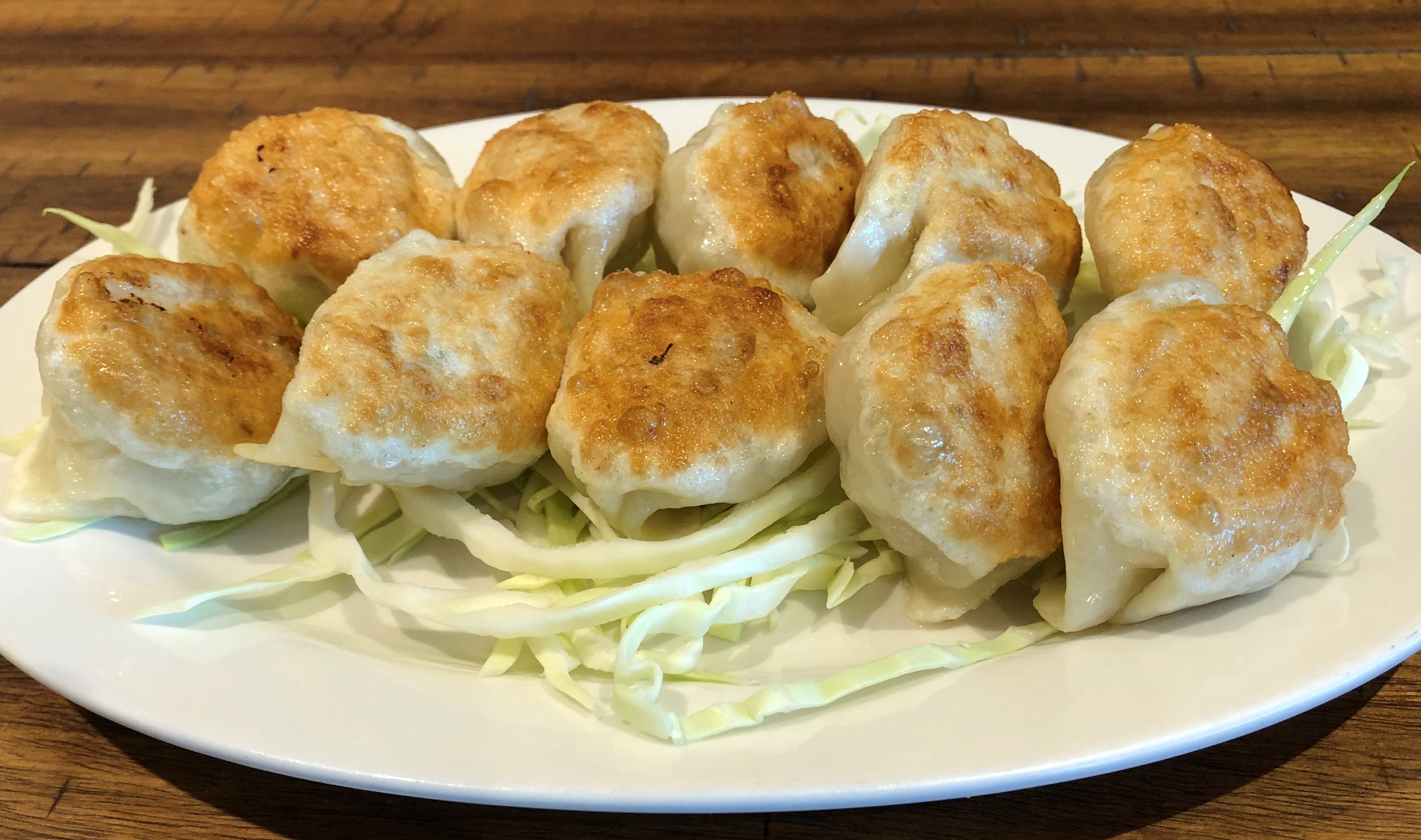Order L12a. Pan Fried Cabbage Pork Dumplings  生煎菜肉饺子 (10) food online from Hai master kitchen store, Laguna Woods on bringmethat.com