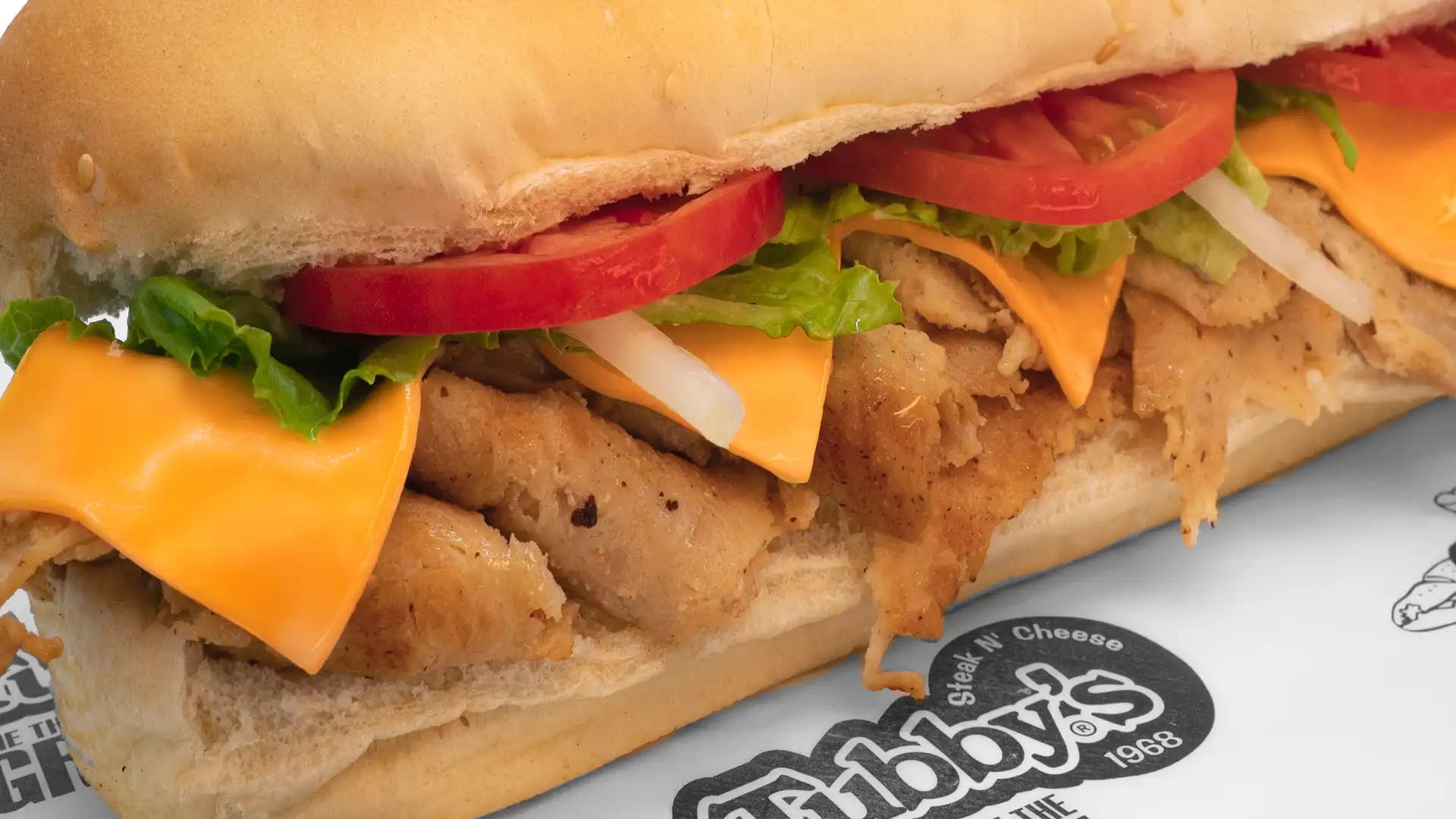 Order Chicken & Cheddar Sub - Small food online from Tubby's Grilled Submarines store, Westland on bringmethat.com