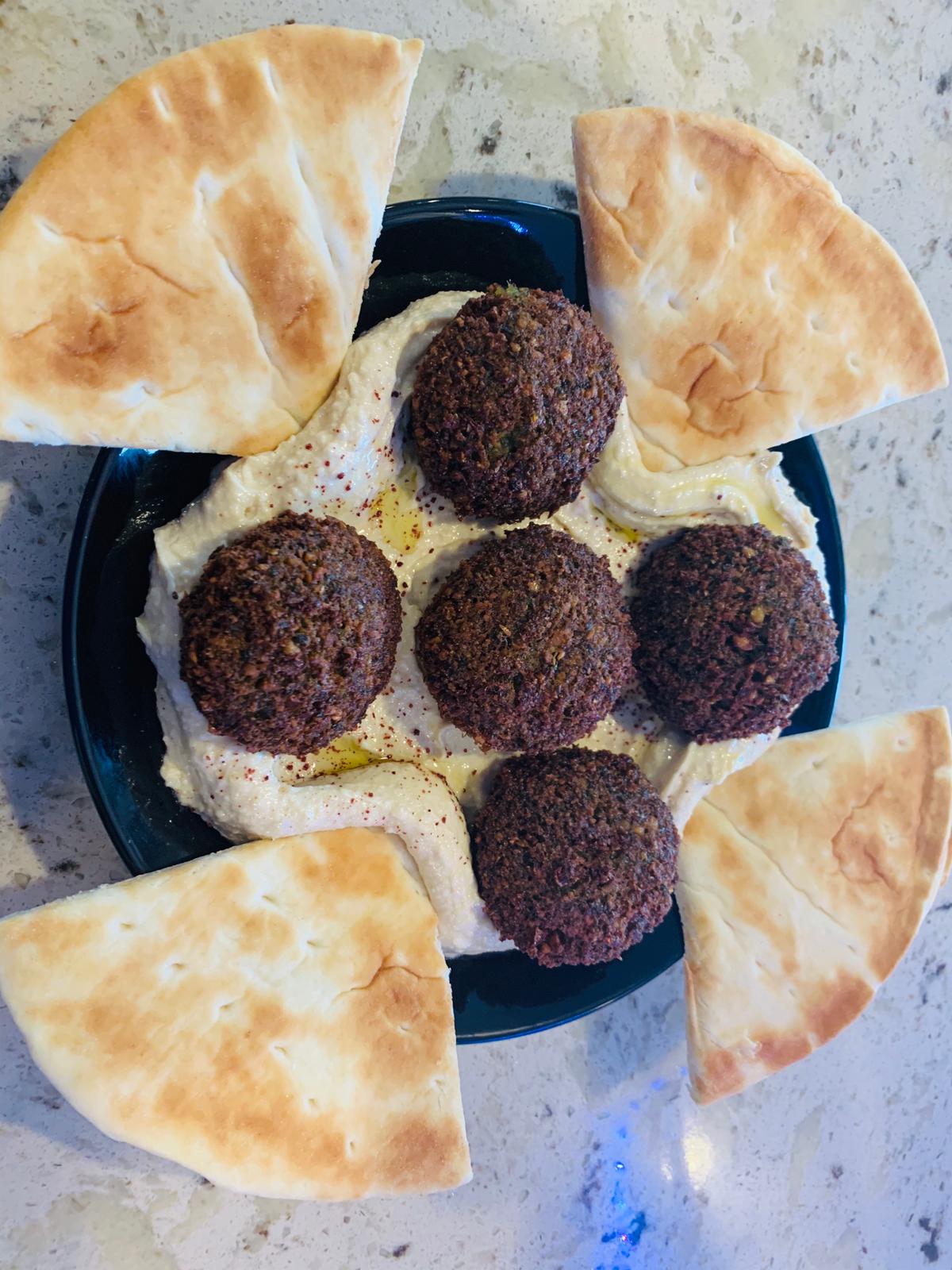 Order falafel over hummus plate food online from Baghdad Gyro store, Beaverton on bringmethat.com
