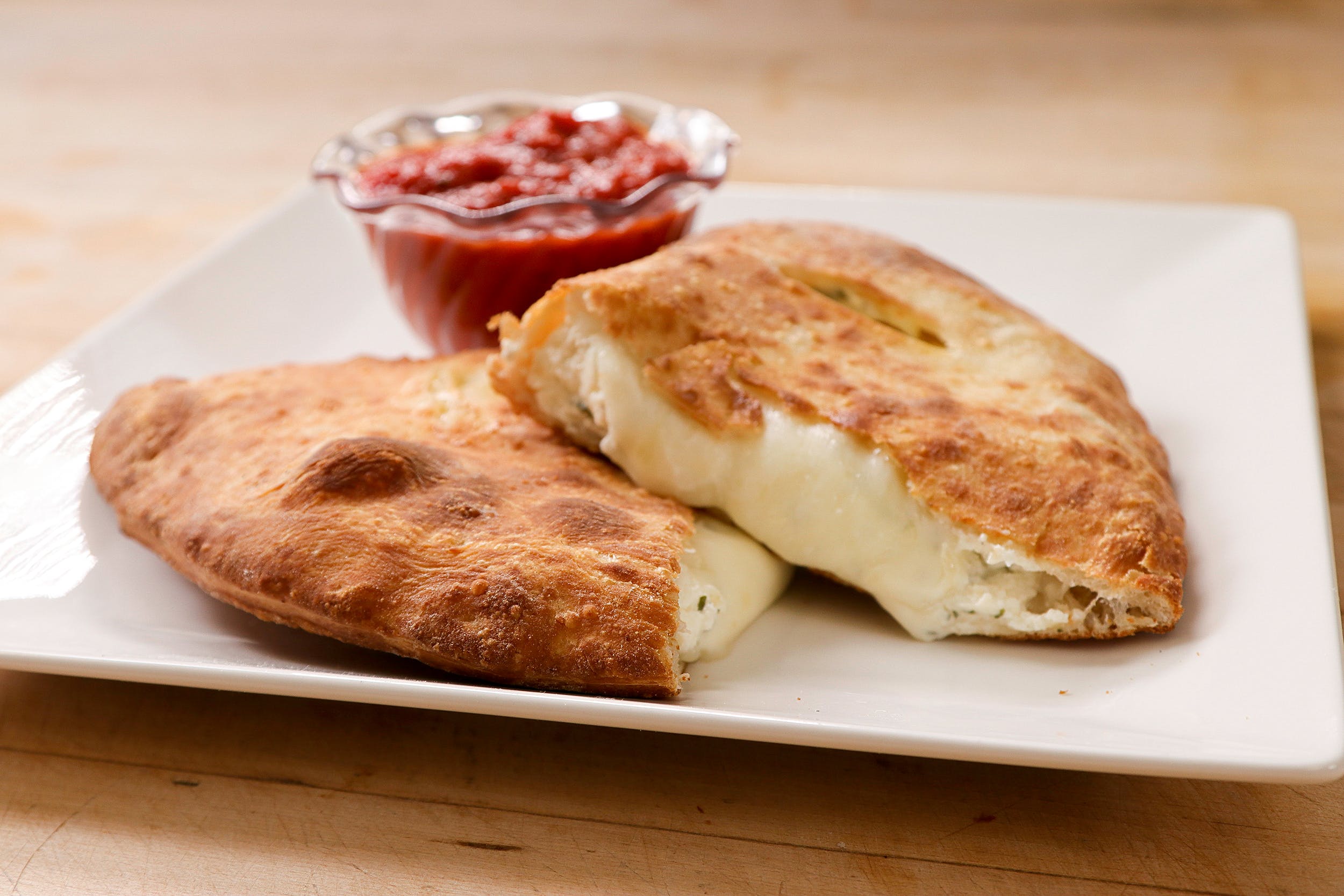 Order Ricotta & Mozzarella Calzone - Calzone food online from Ameci Pizza & Pasta store, Canyon Country on bringmethat.com