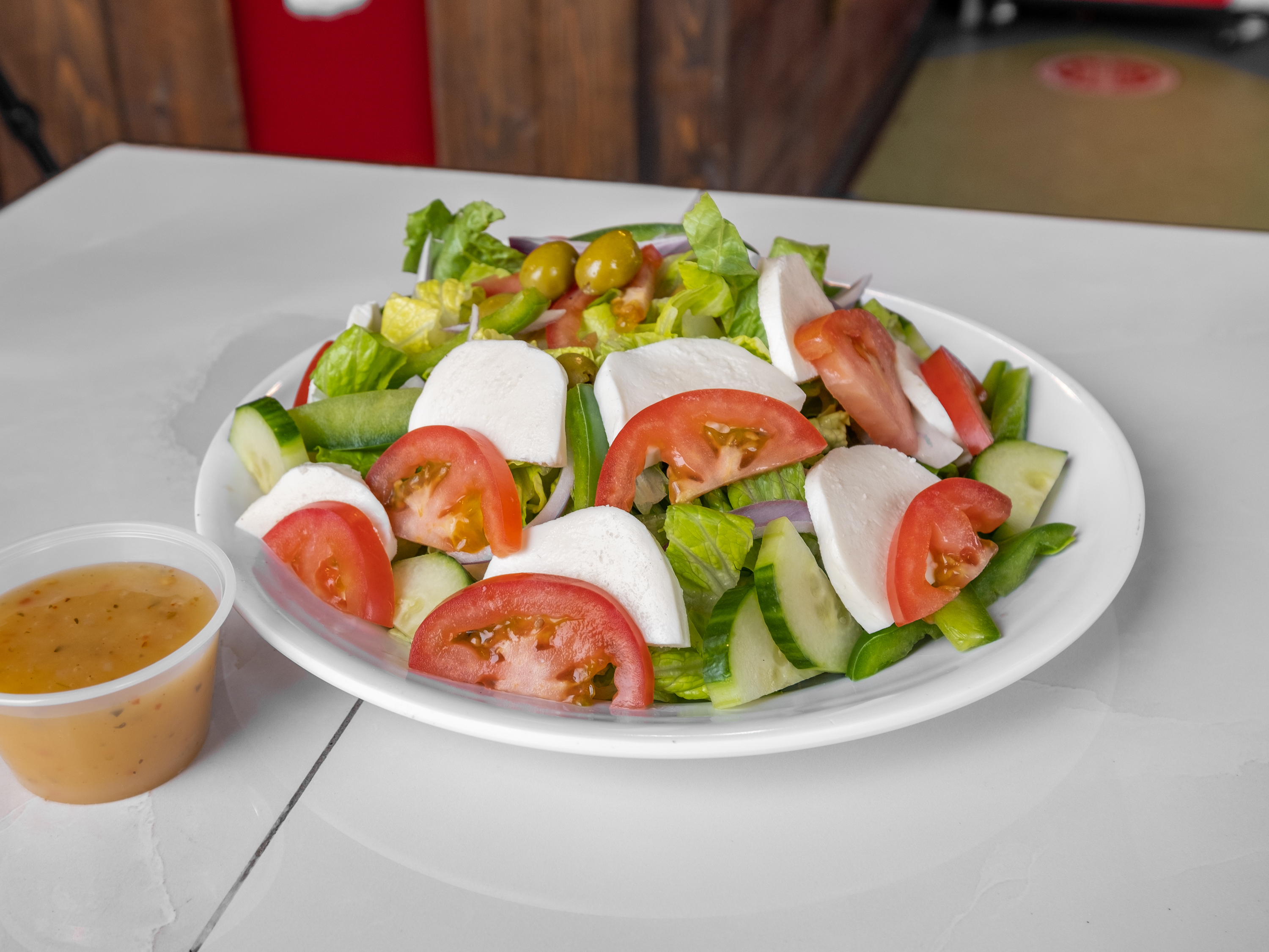 Order Caprese salad is food online from New Yorker Pizza store, Leesburg on bringmethat.com