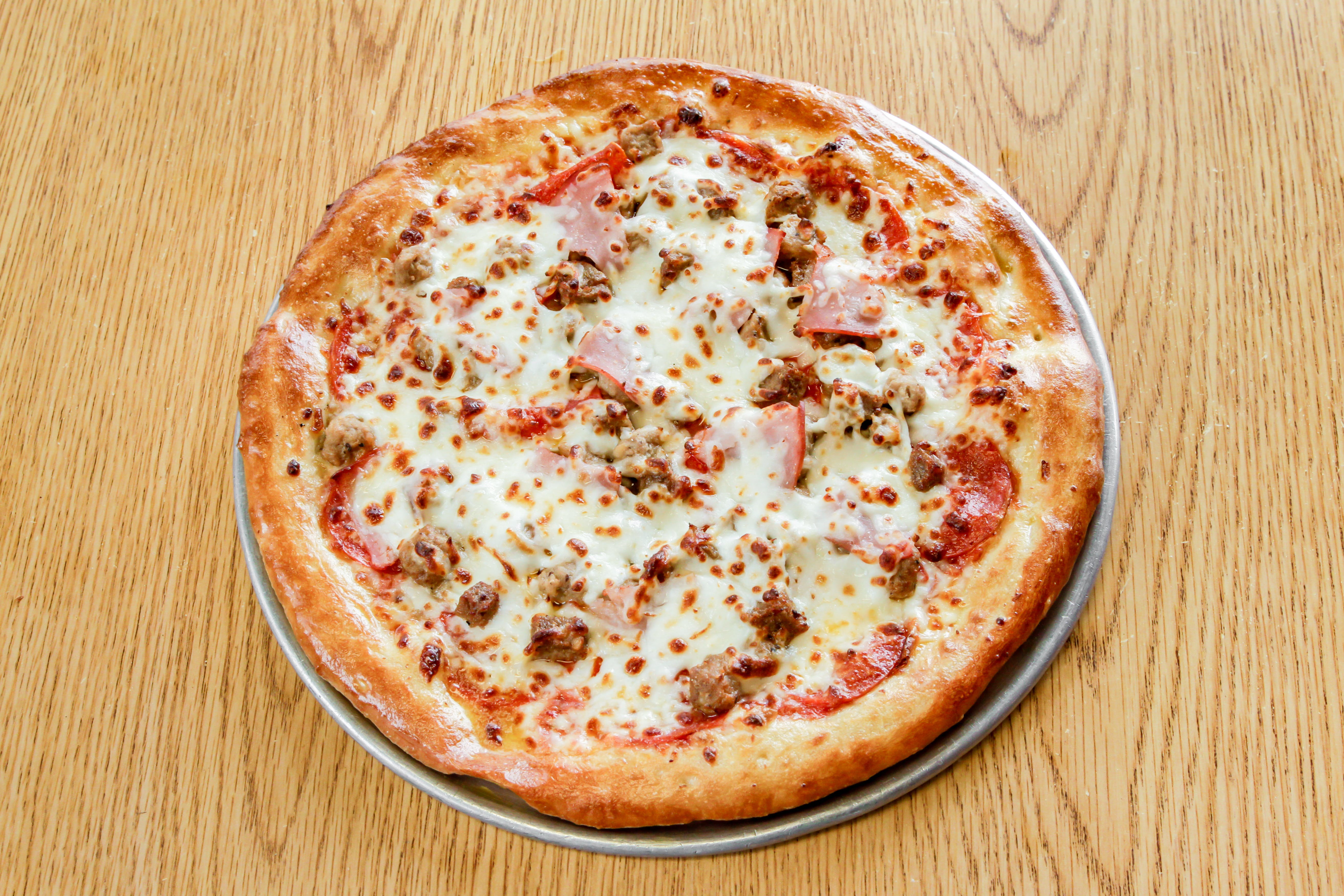 Order Carnivore Pizza - Small 10" food online from Marios Pizza store, Tucson on bringmethat.com