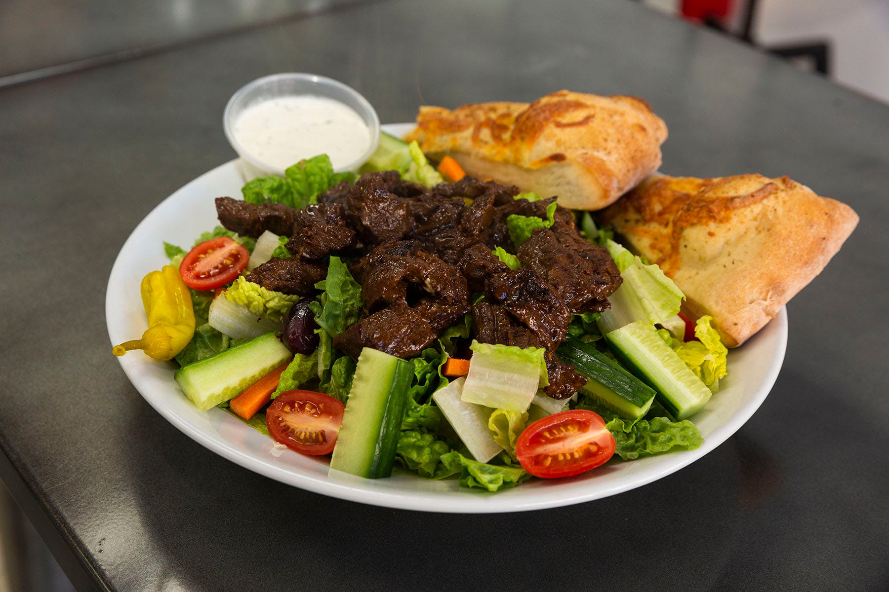 Order Steak Tip Salad - Salads food online from College Pizza store, Boston on bringmethat.com