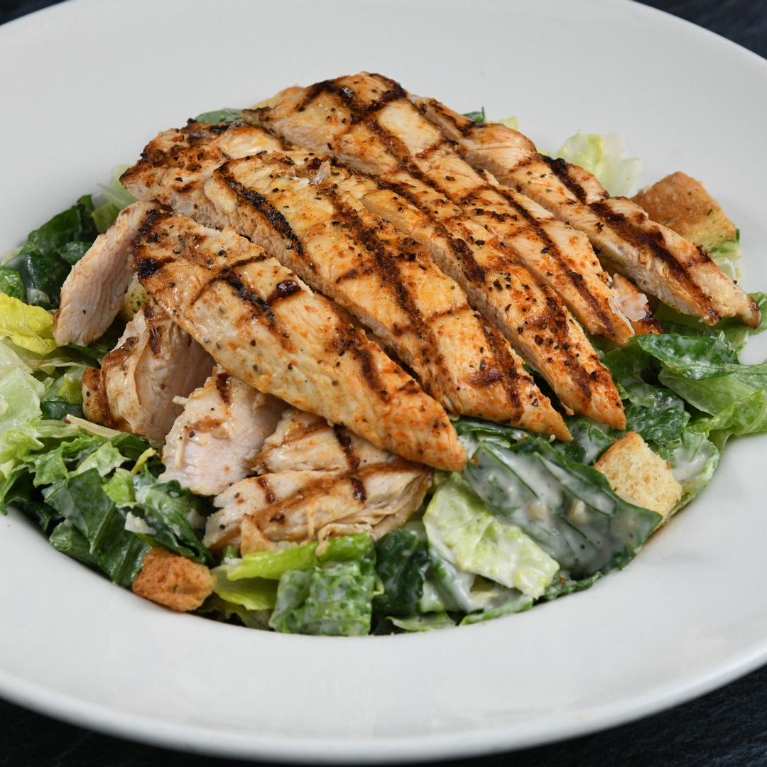 Order Big Islander Caesar Salad With Chicken food online from Rainforest Cafe store, Las Vegas on bringmethat.com