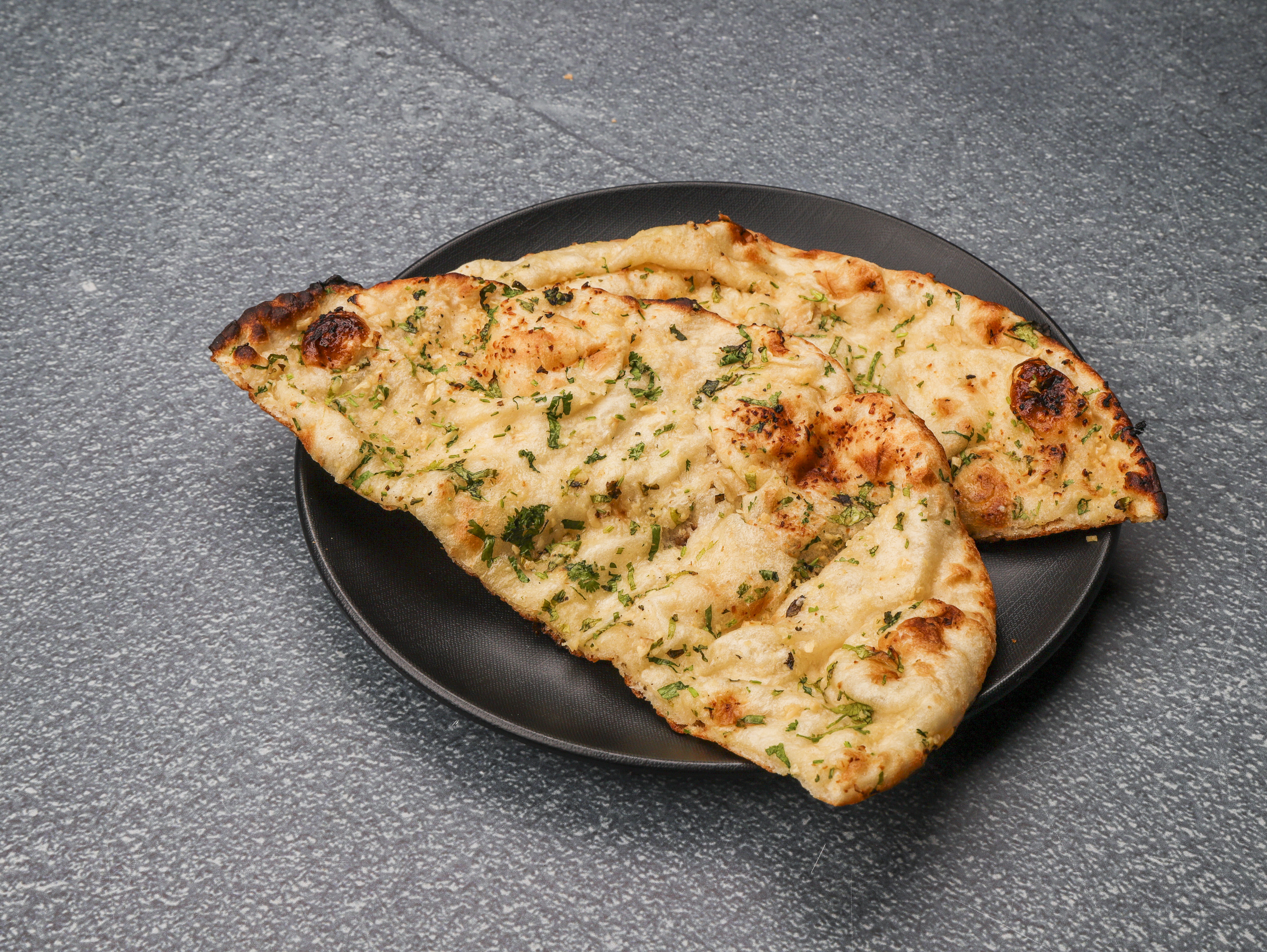Order Garlic Naan food online from Flavors Of India store, Orlando on bringmethat.com