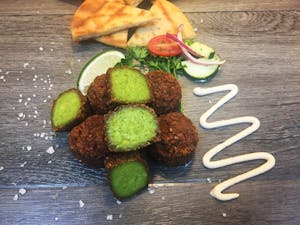 Order Falafel (4) with Tahini food online from Athenian Fresh Grill store, North Arlington on bringmethat.com