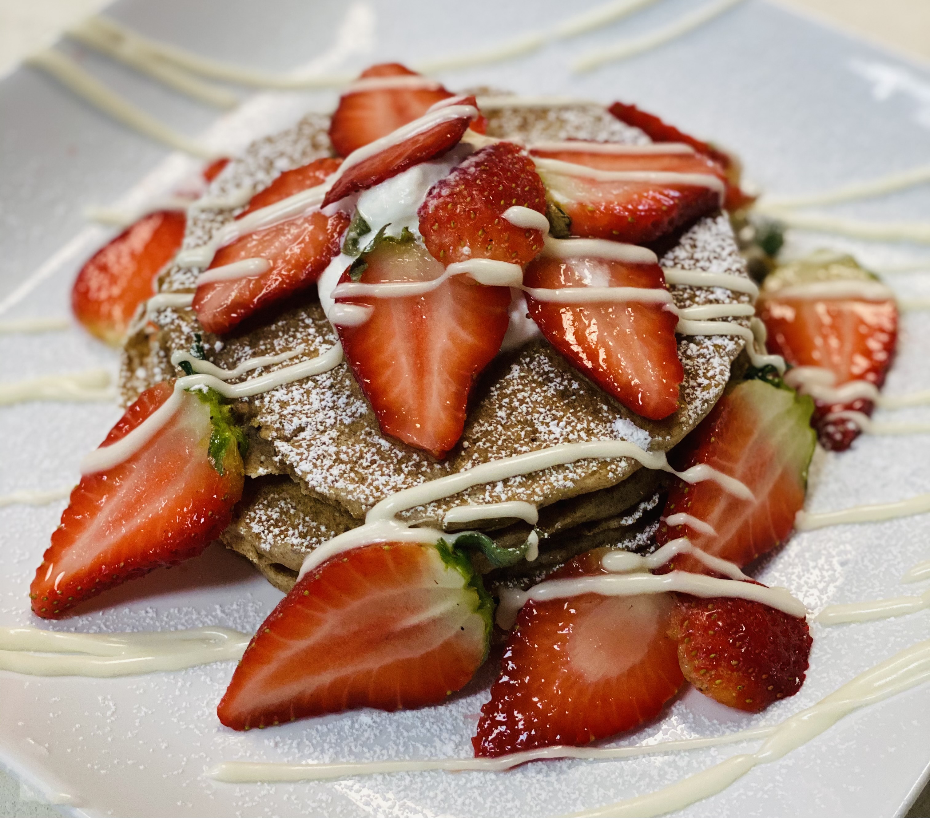 Order Vegan Spelt Pancakes with Strawberries and powder sugar food online from Crave Bakery And Bar store, Chesapeake on bringmethat.com