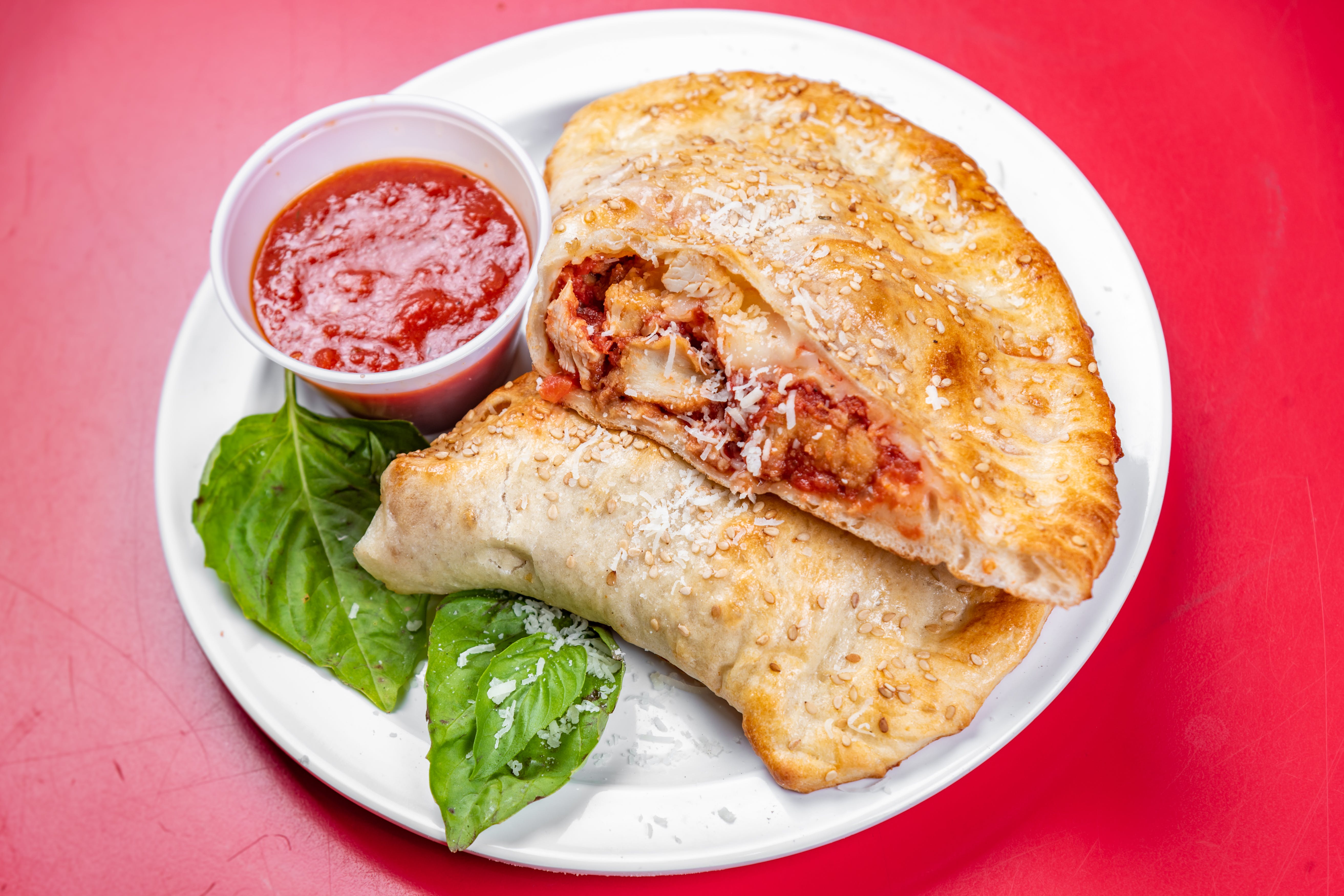 Order Grilled Chicken Parmigiana Calzone - Calzone food online from The grotto pizzeria & ristorante store, New York on bringmethat.com