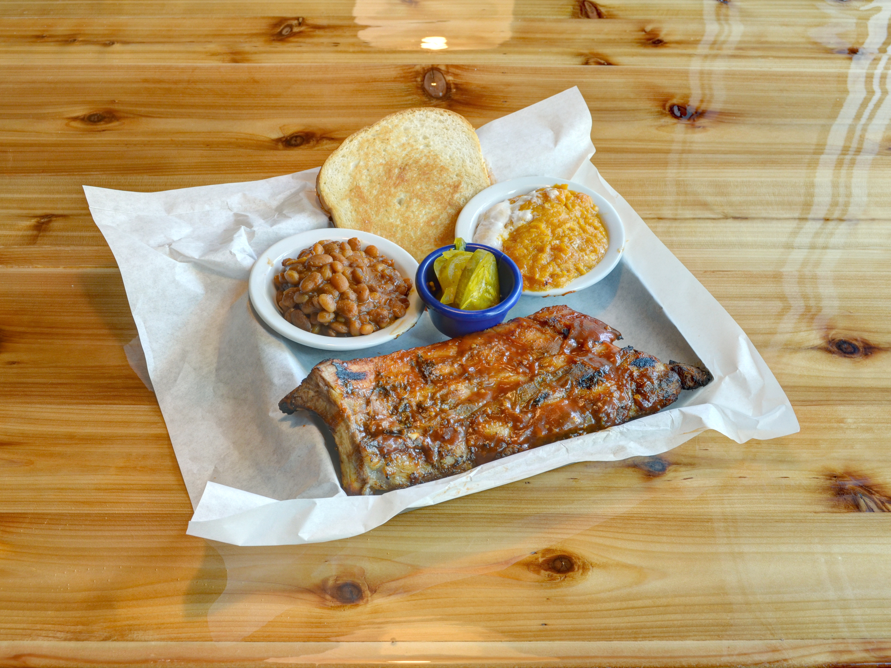 Order Half Rack Ribs food online from Cue Barbecue store, Lawrenceville on bringmethat.com