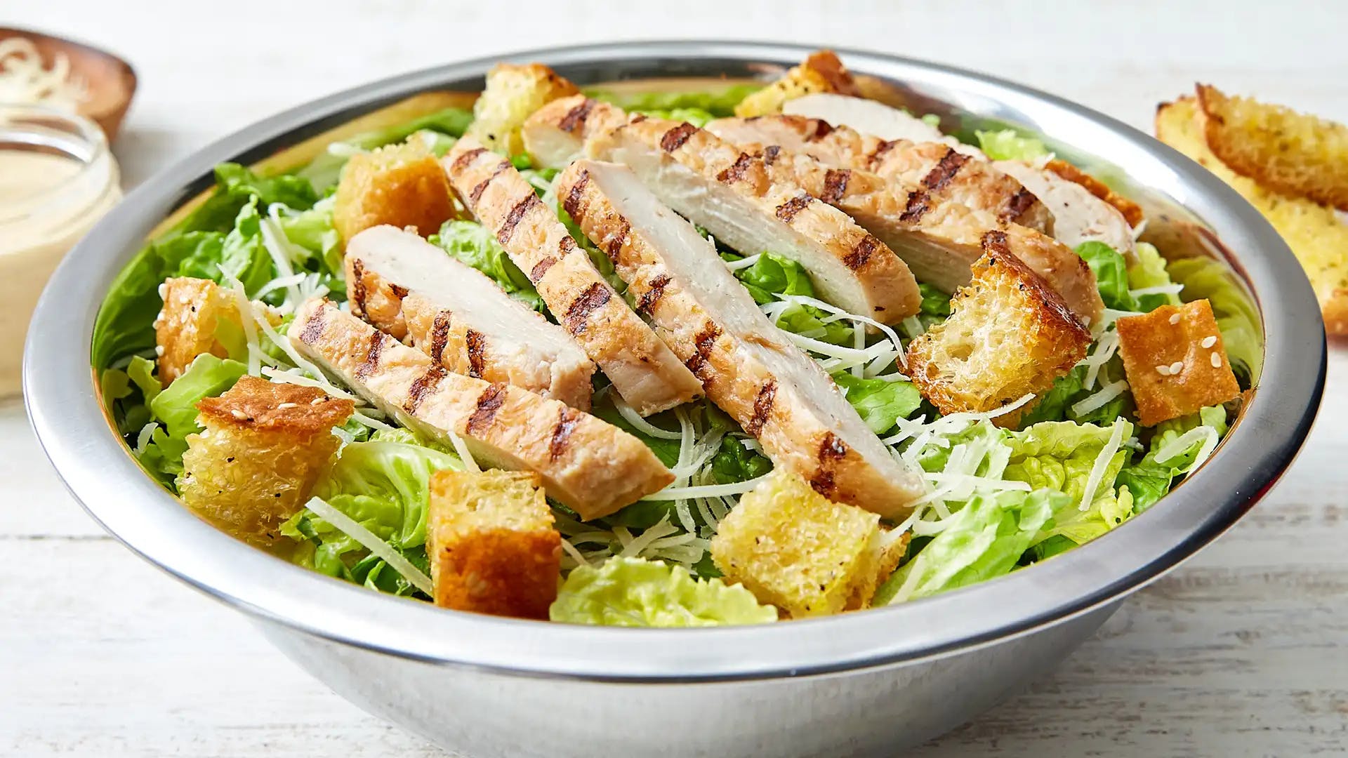 Order Chicken Caesar Salad - Regular food online from Schlotzsky store, Lockhart on bringmethat.com