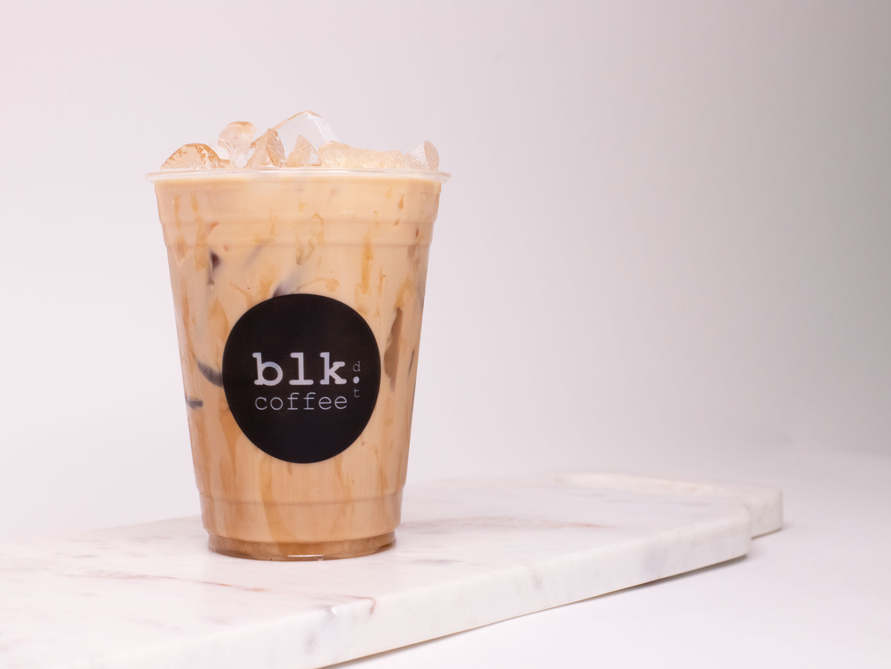 Order Iced Caramel Macchiato Coffee food online from Blk Dot Coffee store, Irvine on bringmethat.com