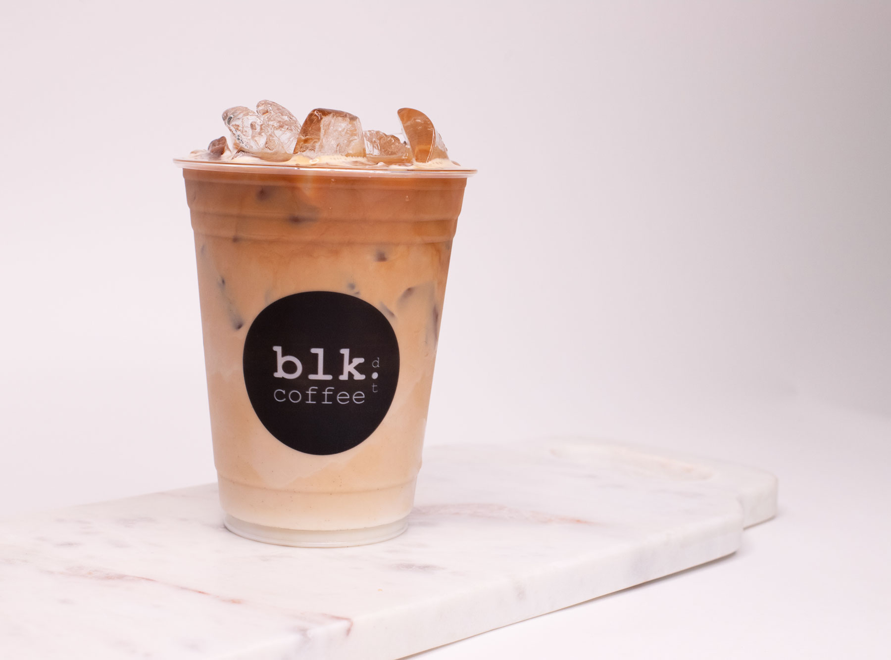 Order Iced Latte Coffee food online from Blk Dot Coffee store, Irvine on bringmethat.com