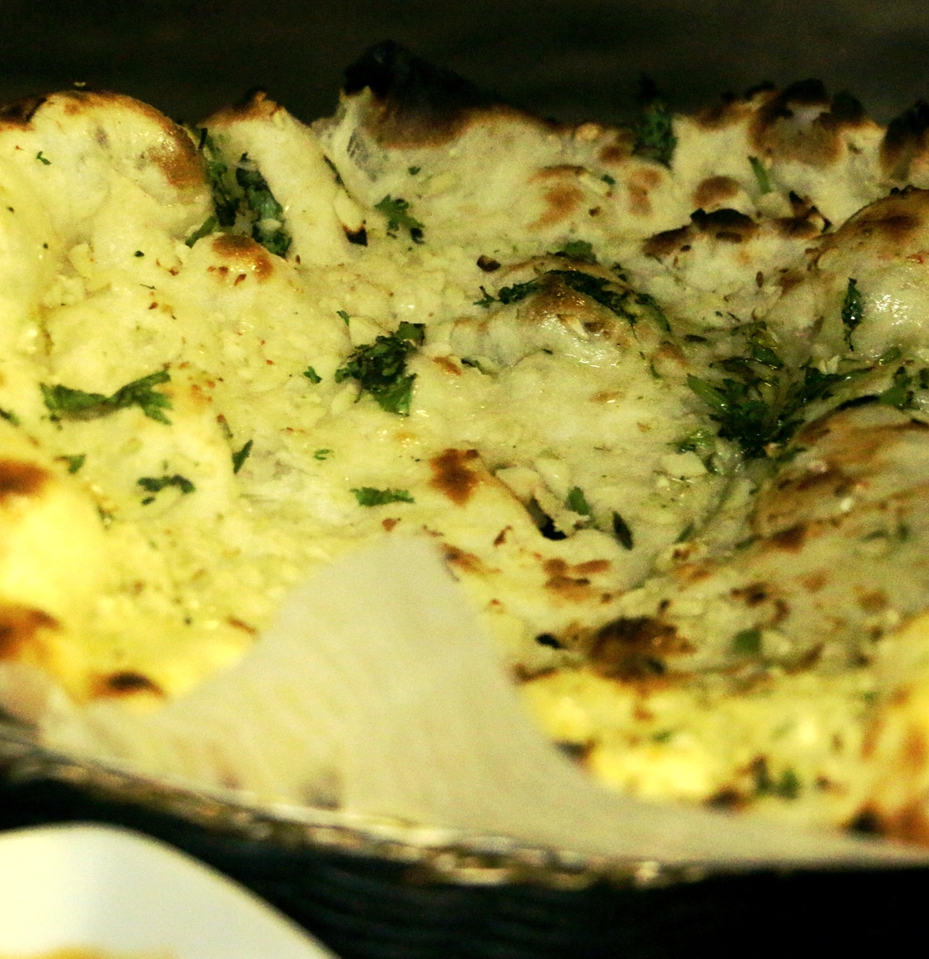 Order 19. Garlic Naan food online from Darbar - E. 46th St. store, New York on bringmethat.com