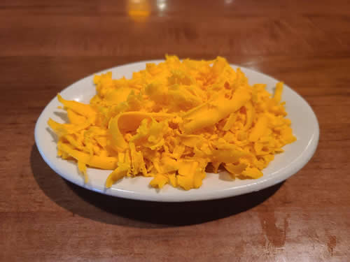 Order Side of Grated Cheddar Cheese food online from La Playa Maya store, Fort Worth on bringmethat.com