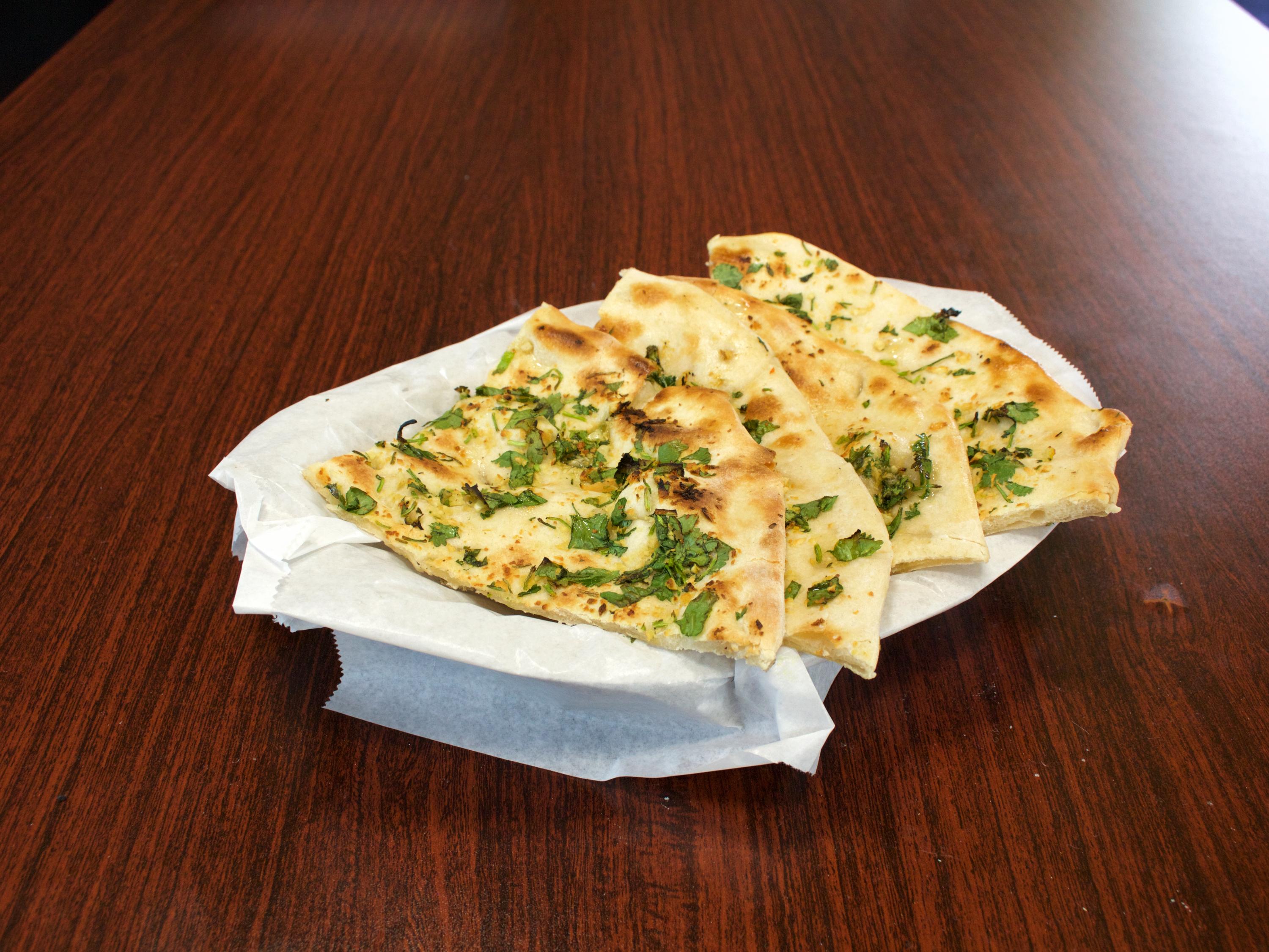 Order Garlic Naan food online from Mother India Cuisine store, Ceres on bringmethat.com