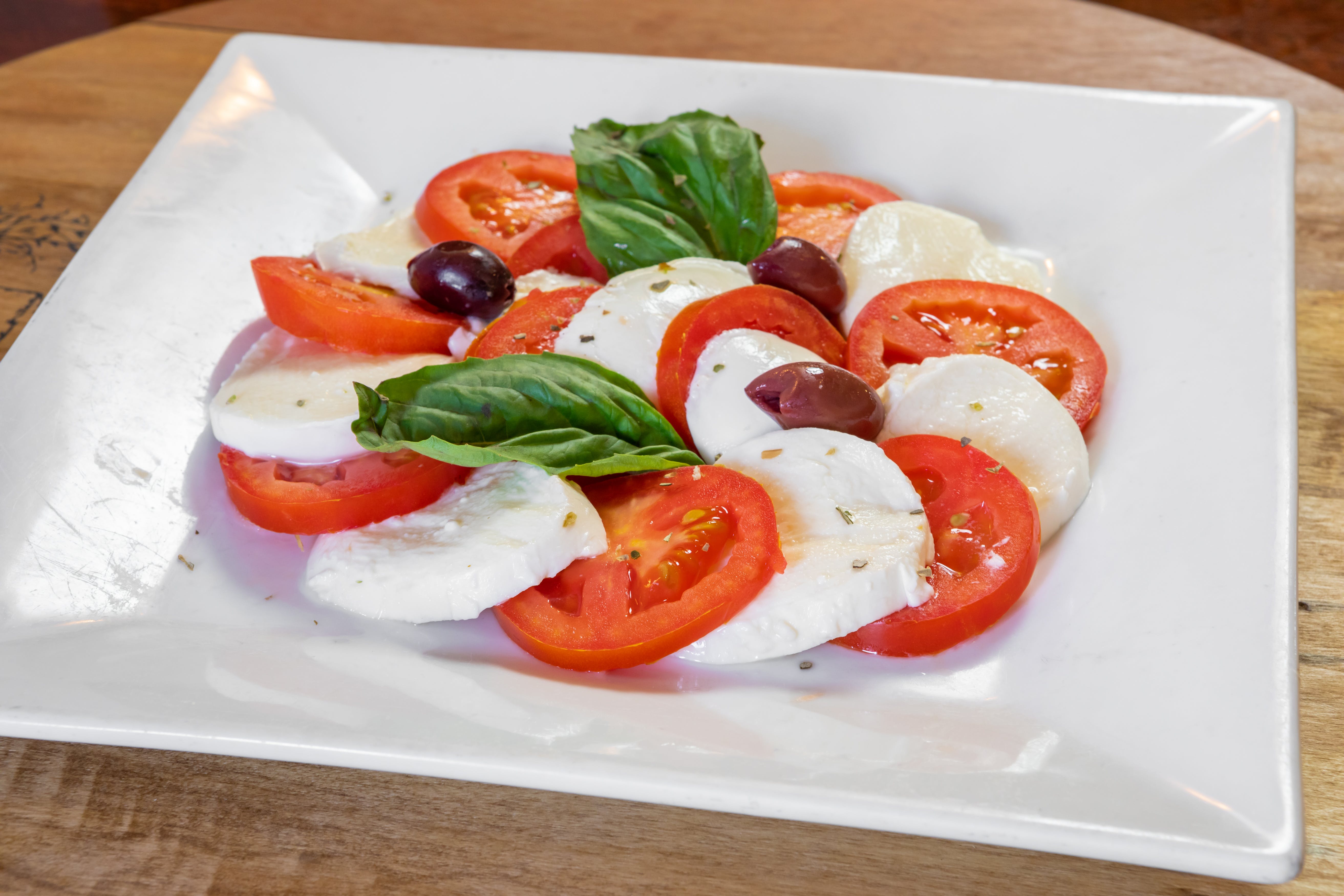 Order Caprese Salad - Salad food online from Capri Restaurant store, Natrona Heights on bringmethat.com