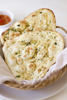 Order 331. Garlic Naan food online from 9 Spices Ballantyne store, Charlotte on bringmethat.com
