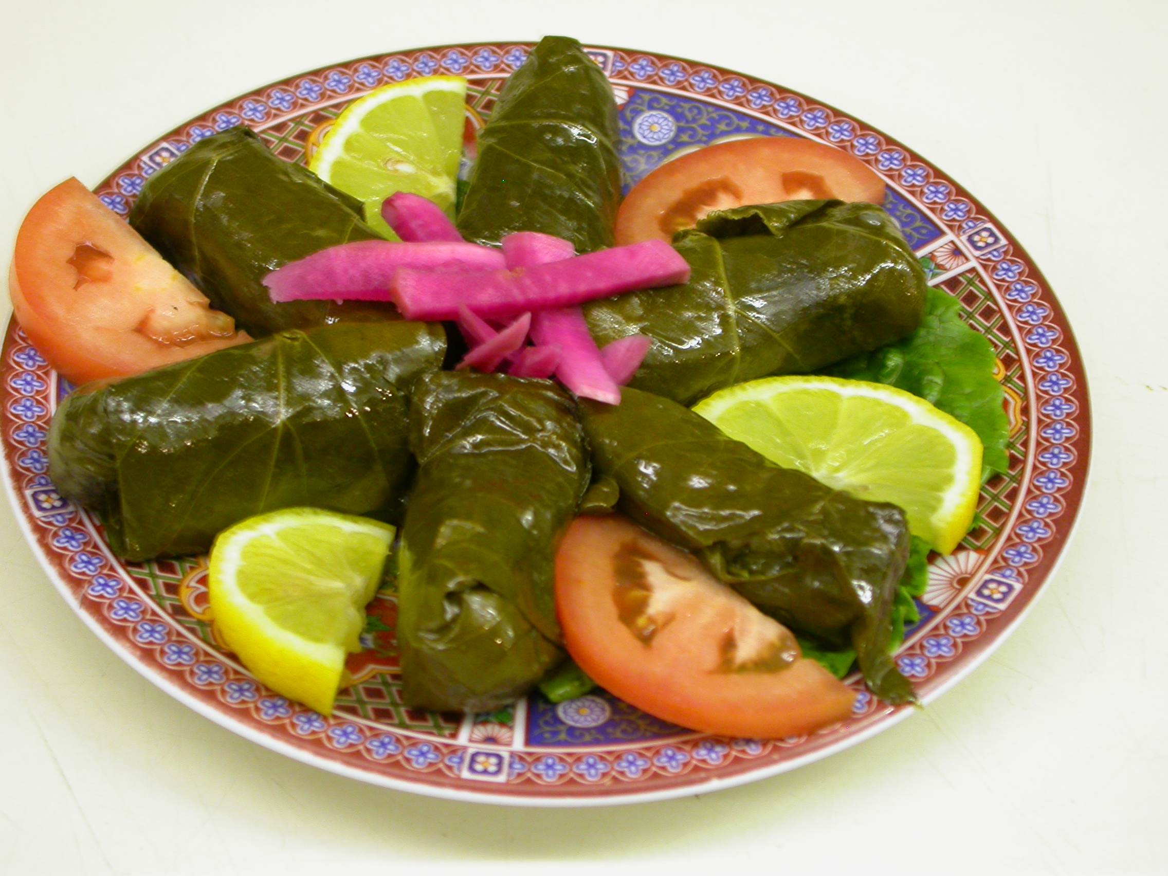 Order Stuffed Grape Leaves (V) (6 Pieces) food online from Ali Baba store, Newark on bringmethat.com