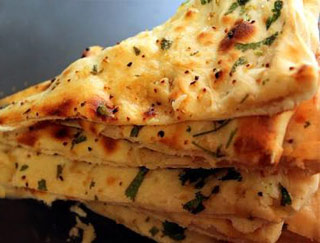 Order Garlic Naan food online from Little India store, Yuba City on bringmethat.com