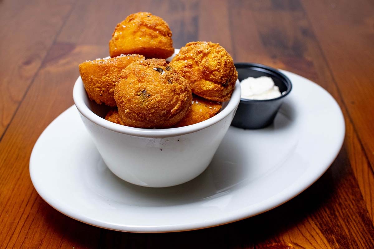 Order Hush Puppies food online from Boudreaux's Cajun Kitchen store, Houston on bringmethat.com