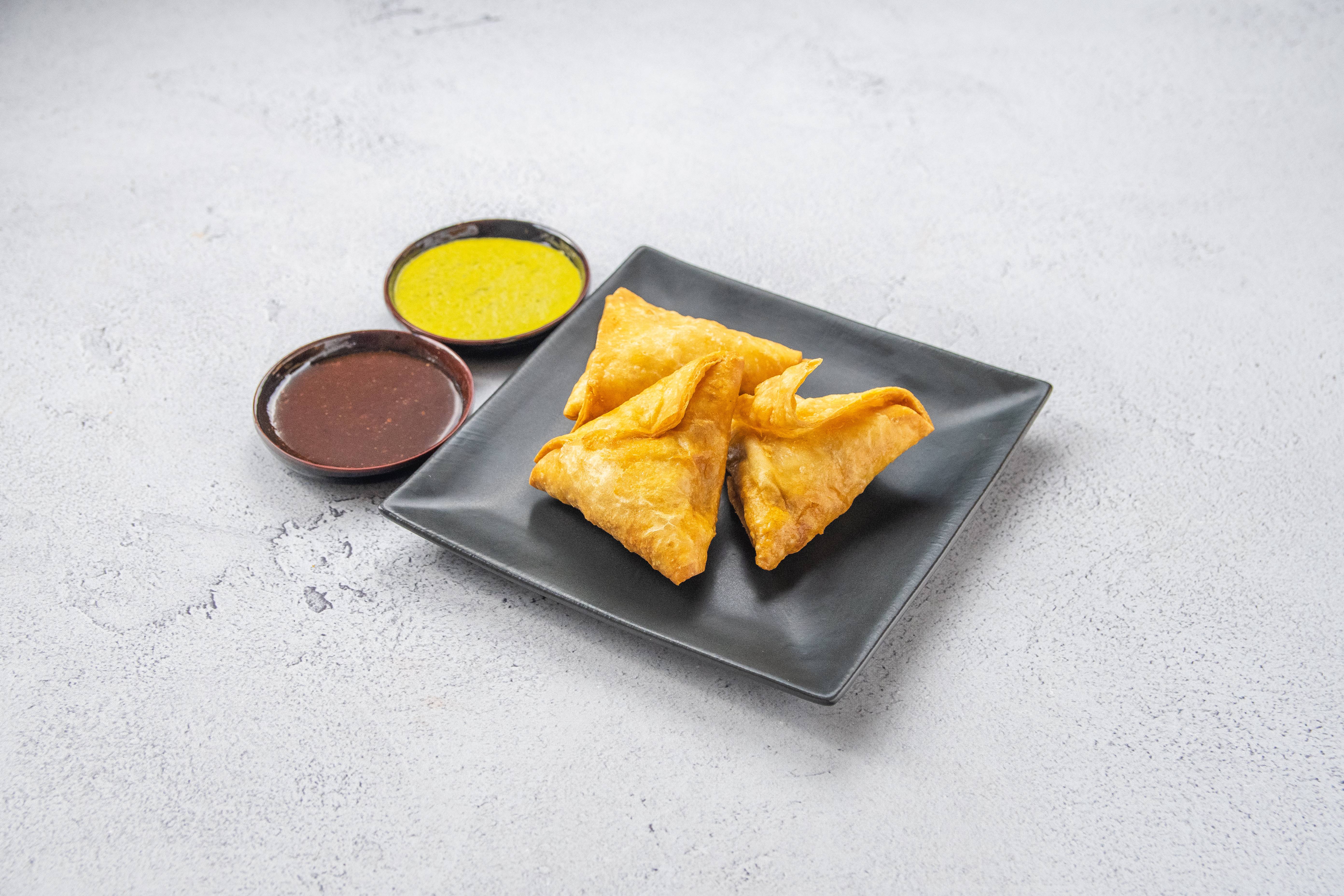 Order A1. Vegetable Samosas food online from Mother India Restaurant store, Chatsworth on bringmethat.com