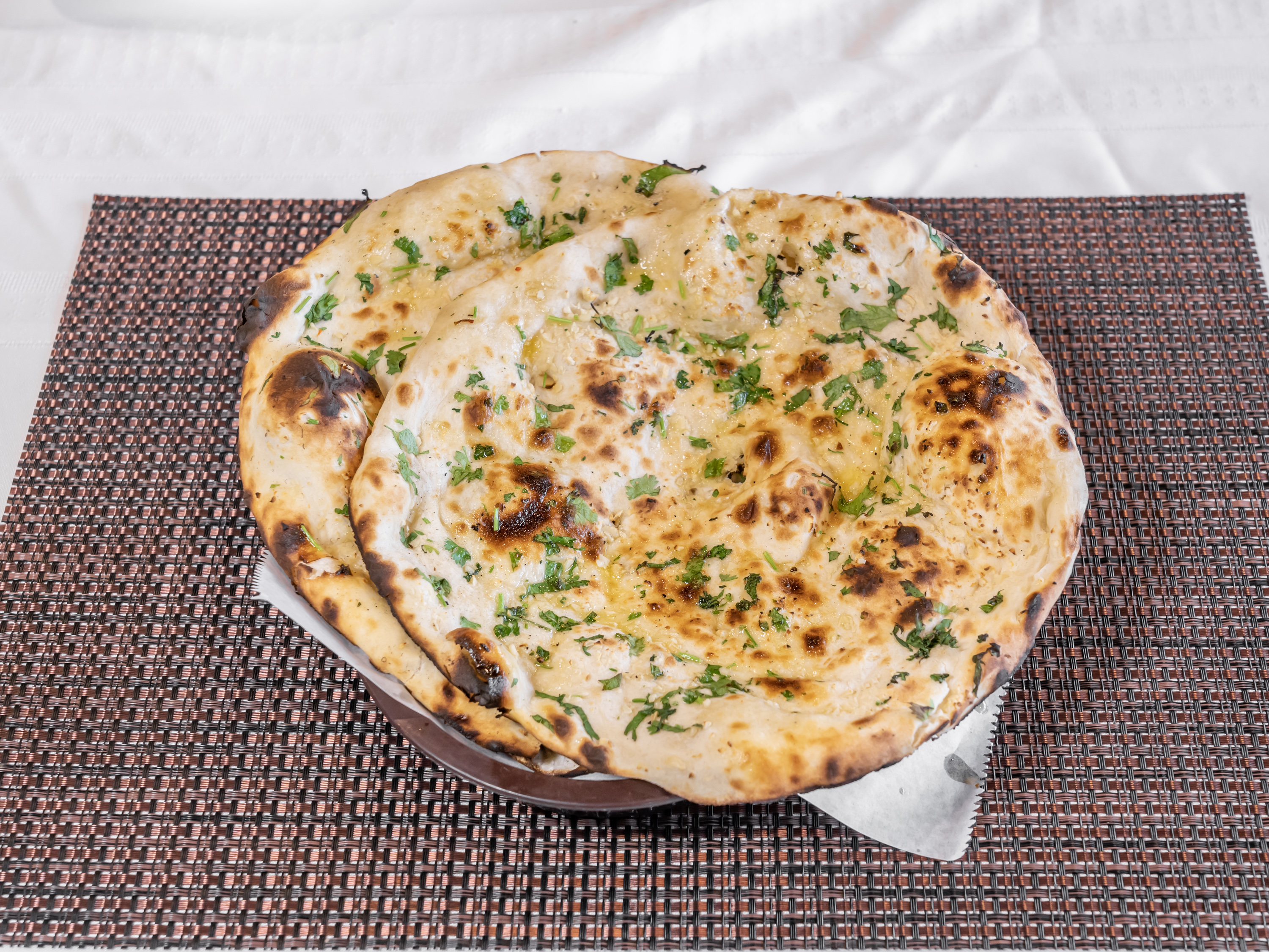 Order 92. Garlic Naan food online from Charminar Biryani House store, Troy on bringmethat.com