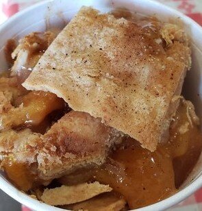 Order Serving of Peach Cobbler food online from Rudy's BBQ store, San Antonio on bringmethat.com