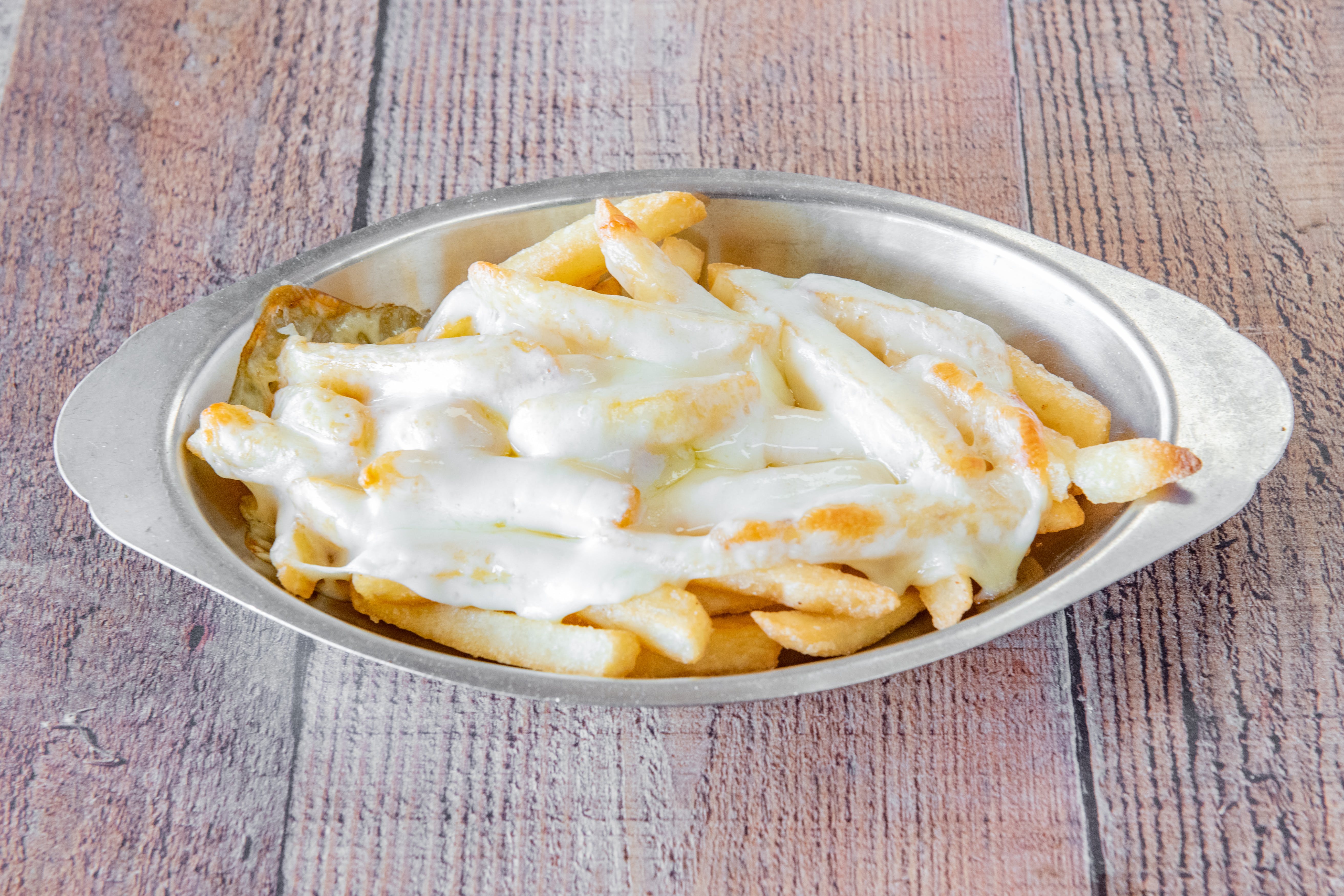 Order French Fries with Cheese - Side food online from Tonys Pizzeria & Italian Restaurant store, Audubon on bringmethat.com