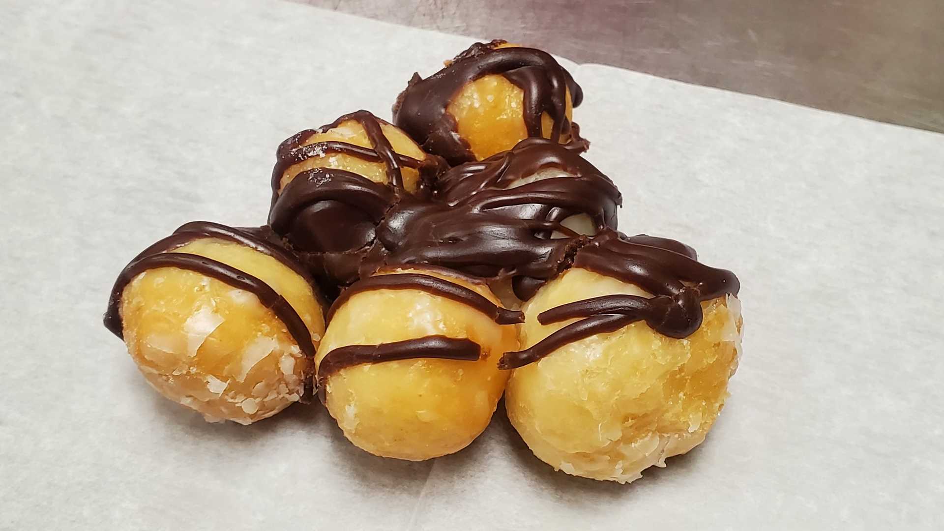 Order Chocolate Drizzle Donut Holes food online from Shipley Do-Nuts store, Clarksville on bringmethat.com