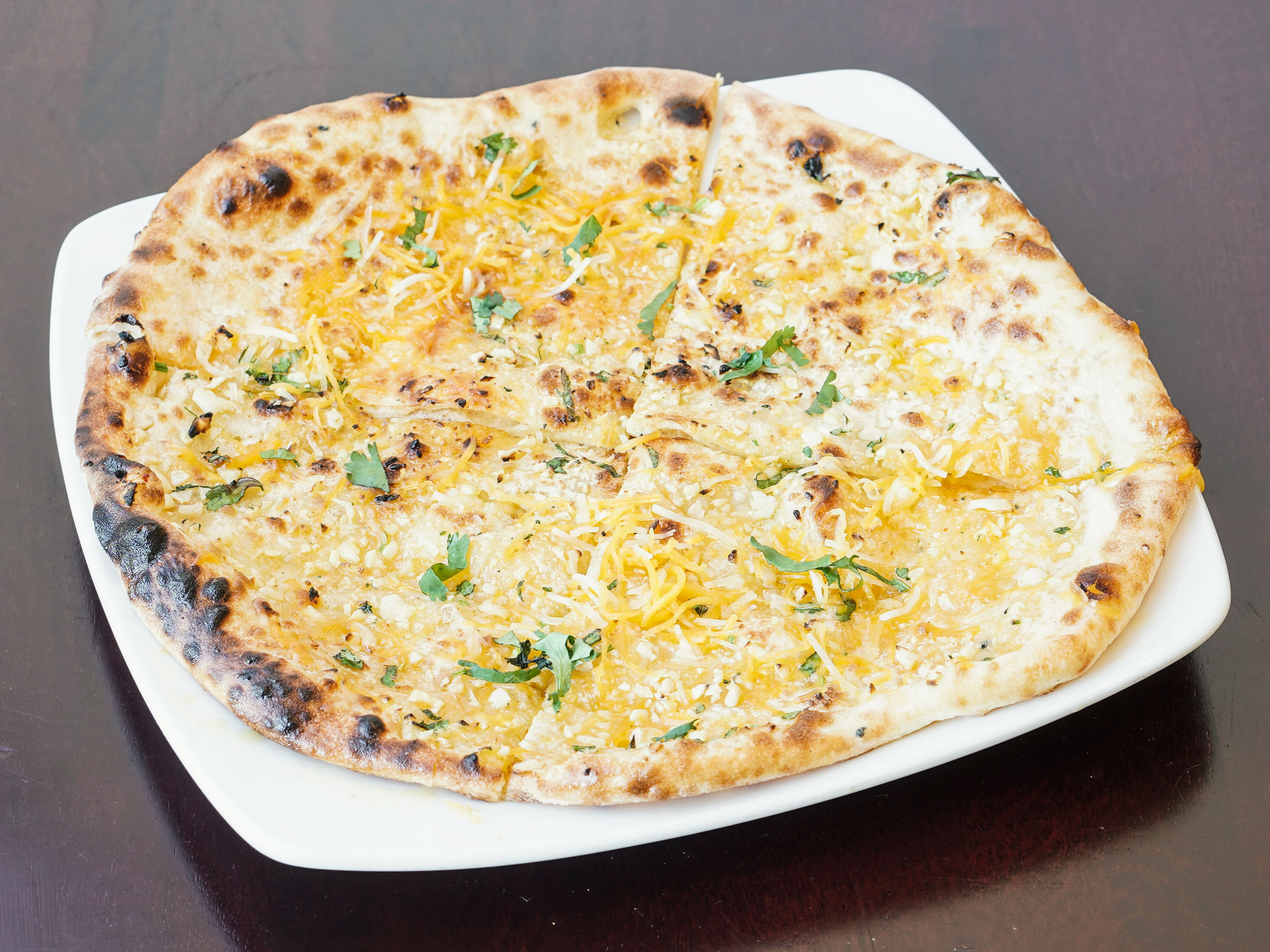 Order Garlic Cheese Naan food online from Nawab Bangladeshi Cuisine store, Dunwoody on bringmethat.com