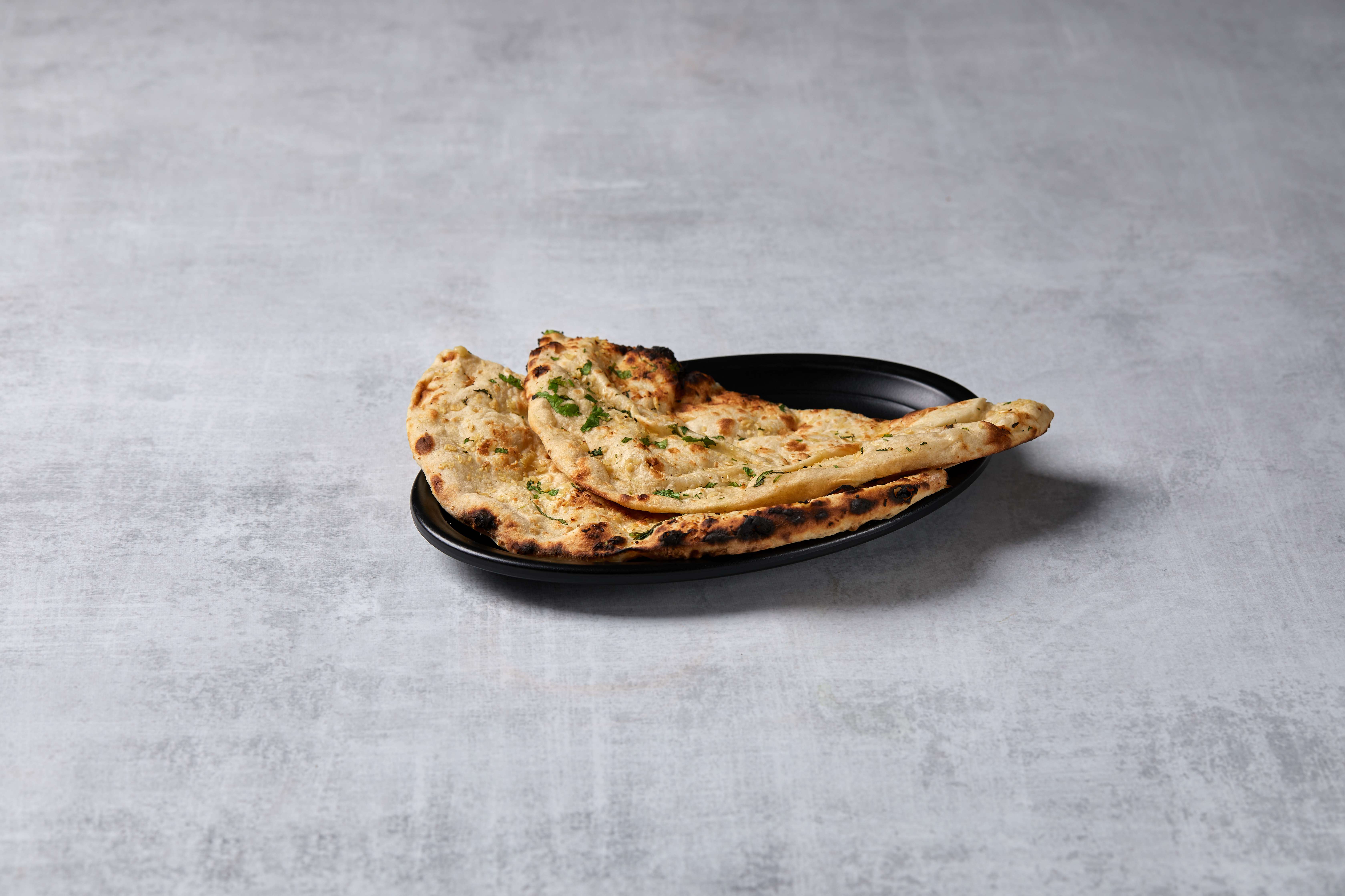 Order Garlic Naan food online from Kamal Palace Cuisine of India store, Long Beach on bringmethat.com