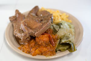 Order Smothered Pork Chops Plate food online from Houston This Is It Cafe store, Houston on bringmethat.com