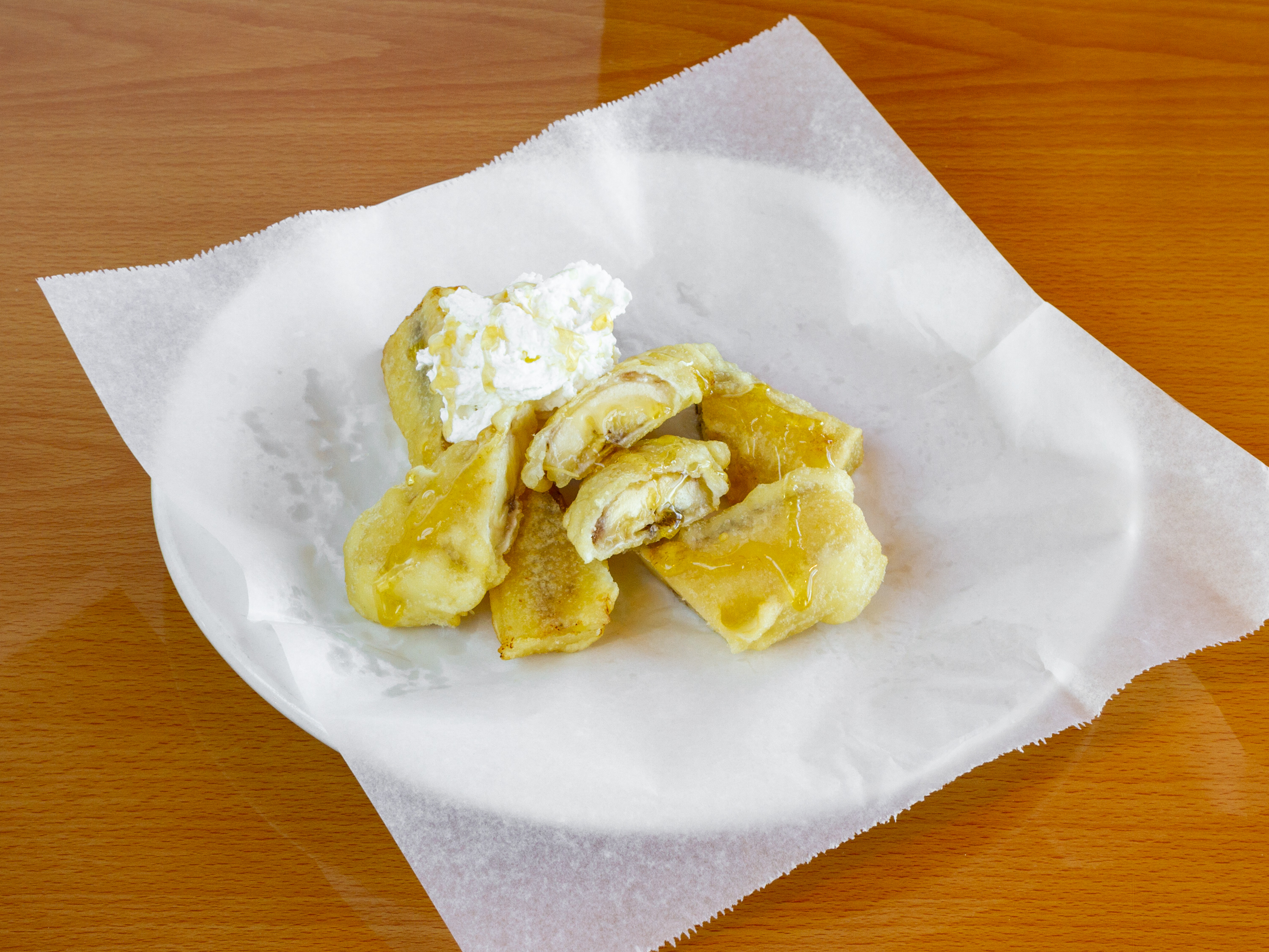 Order 74. Fresh Fried Banana with Whipped Cream & Honey food online from Ha Long Bay store, Tucson on bringmethat.com