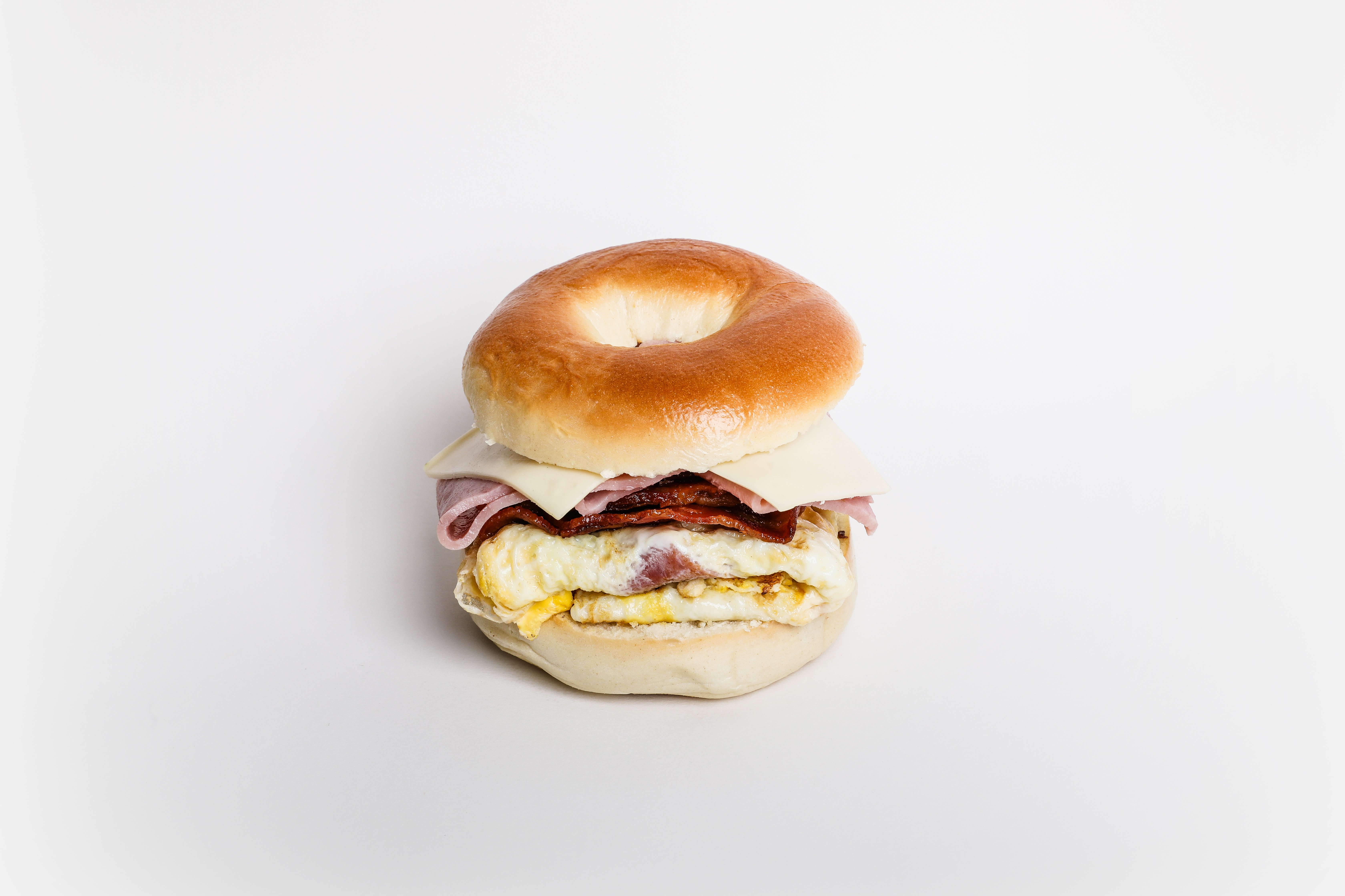 Order 3. Ham, Eggs, Sausage, Bacon and Cheese Bagel food online from Dc Cafe Donuts store, Reseda on bringmethat.com