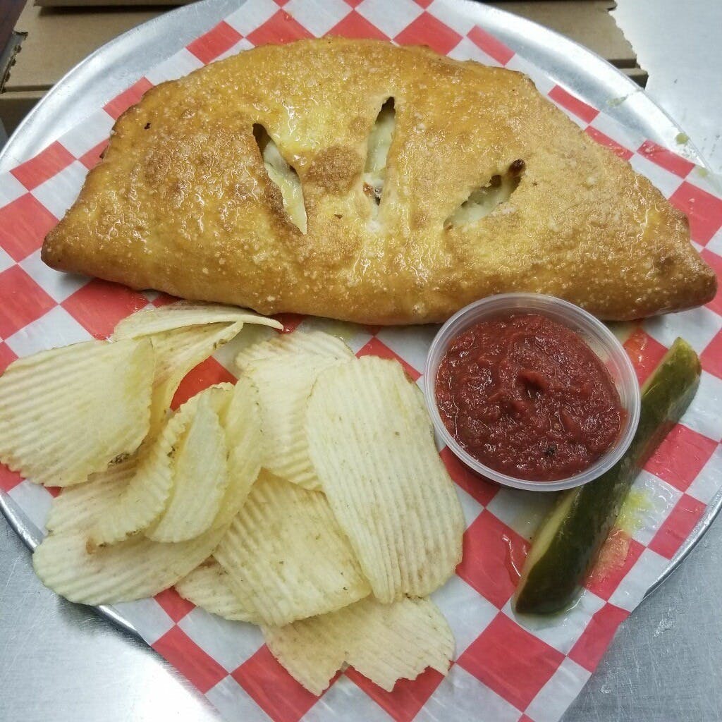 Order Calzone with Four Toppings - Calzone food online from Marino's Pizza store, Spring Arbor on bringmethat.com