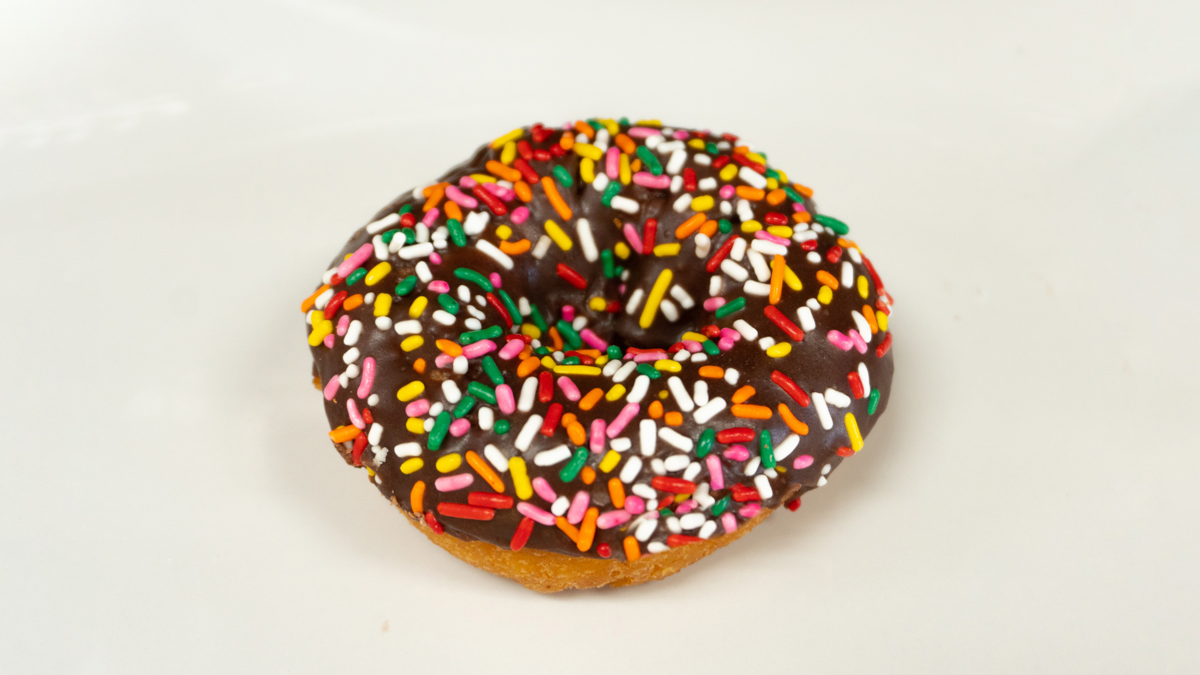 Order Chocolate Frosting Cake Donut food online from Rainbow Donuts store, Norwalk on bringmethat.com