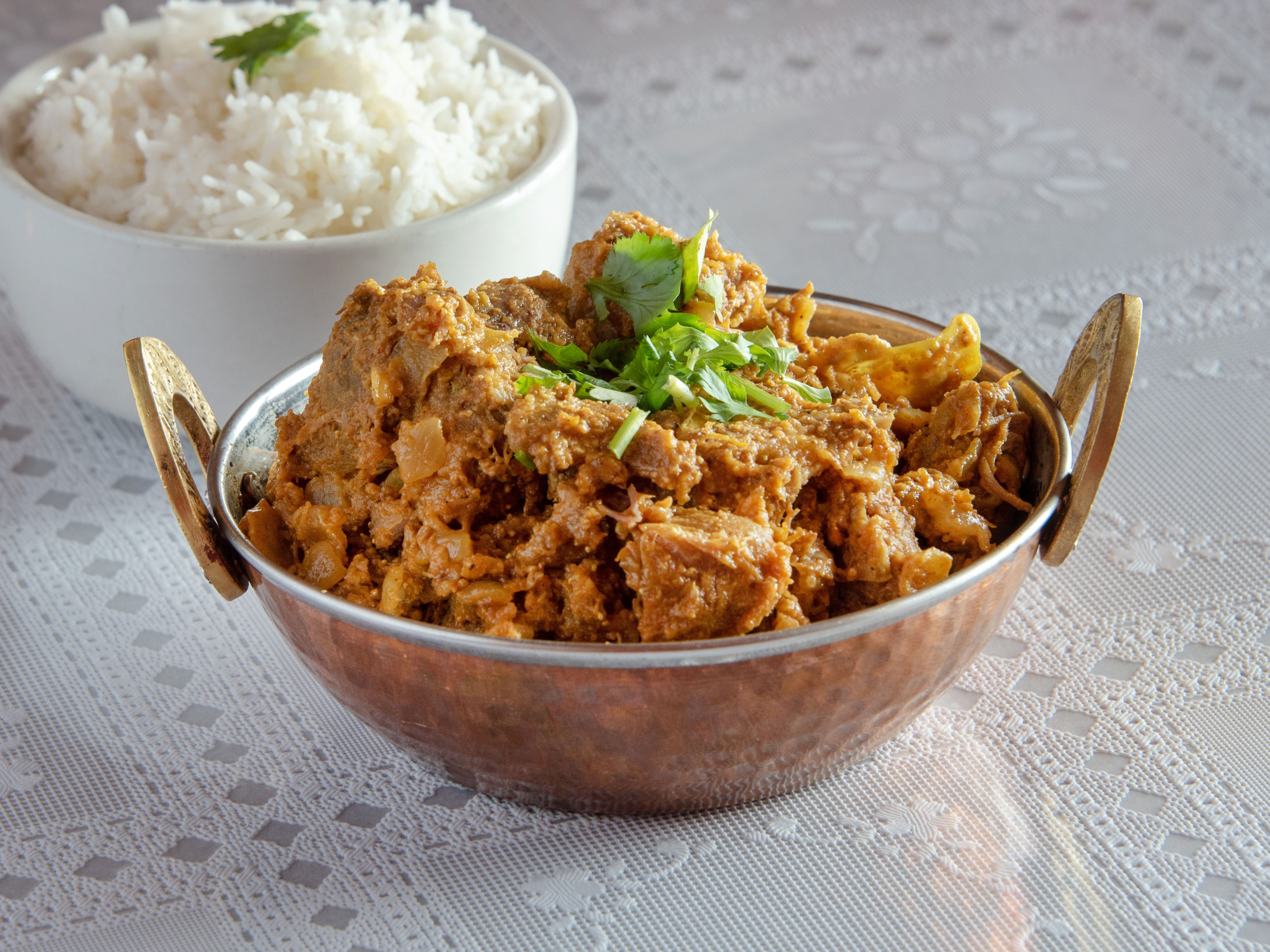 Order Goat Curry food online from Flavors Indian Cuisine store, Bentonville on bringmethat.com