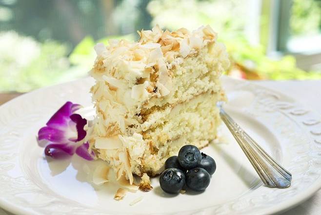 Order Coconut Royale Cake slice food online from Urth Caffe 專覃 store, Santa Monica on bringmethat.com