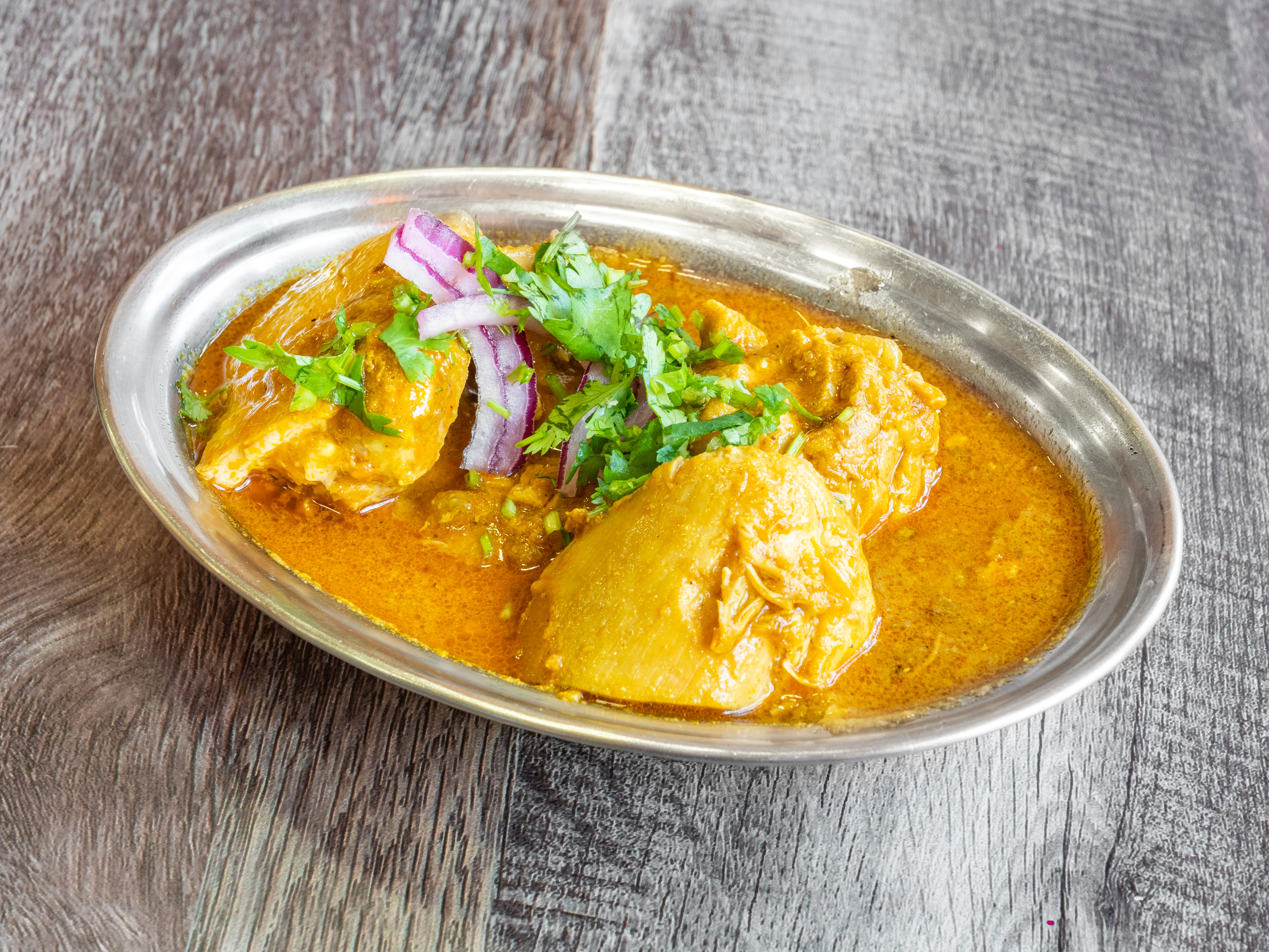 Order Murgh Curry food online from Urban Momo store, San Mateo on bringmethat.com