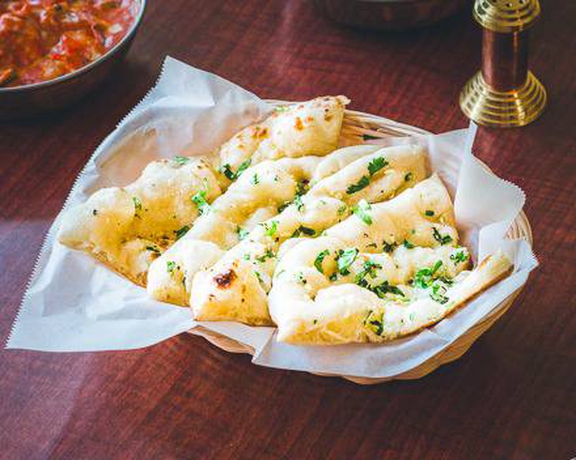 Order Garlic Naan food online from Deccan House store, San Francisco on bringmethat.com